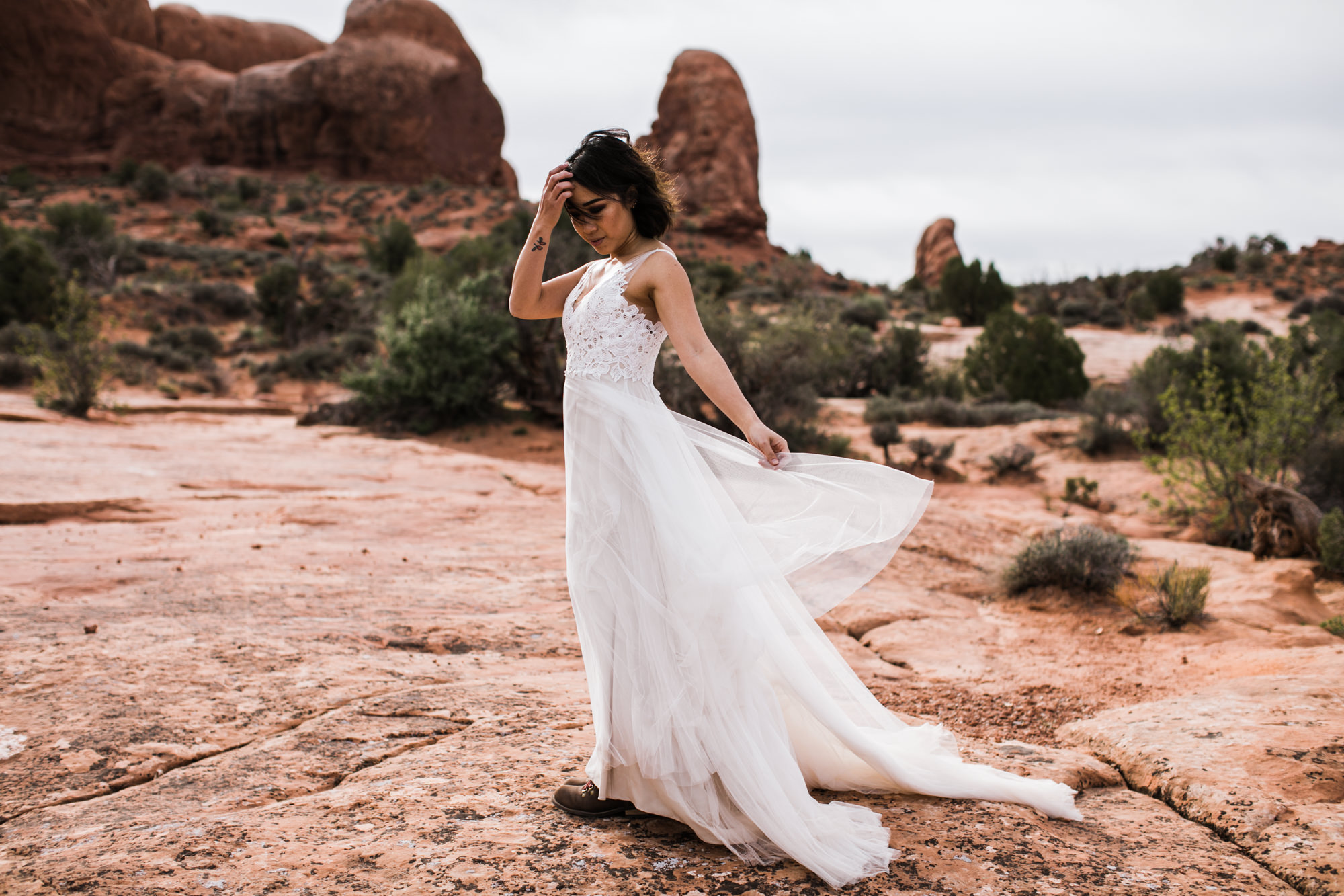 elopement first look in arches national park | desert elopement | moab wedding photographer | the hearnes adventure photography | www.thehearnes.com