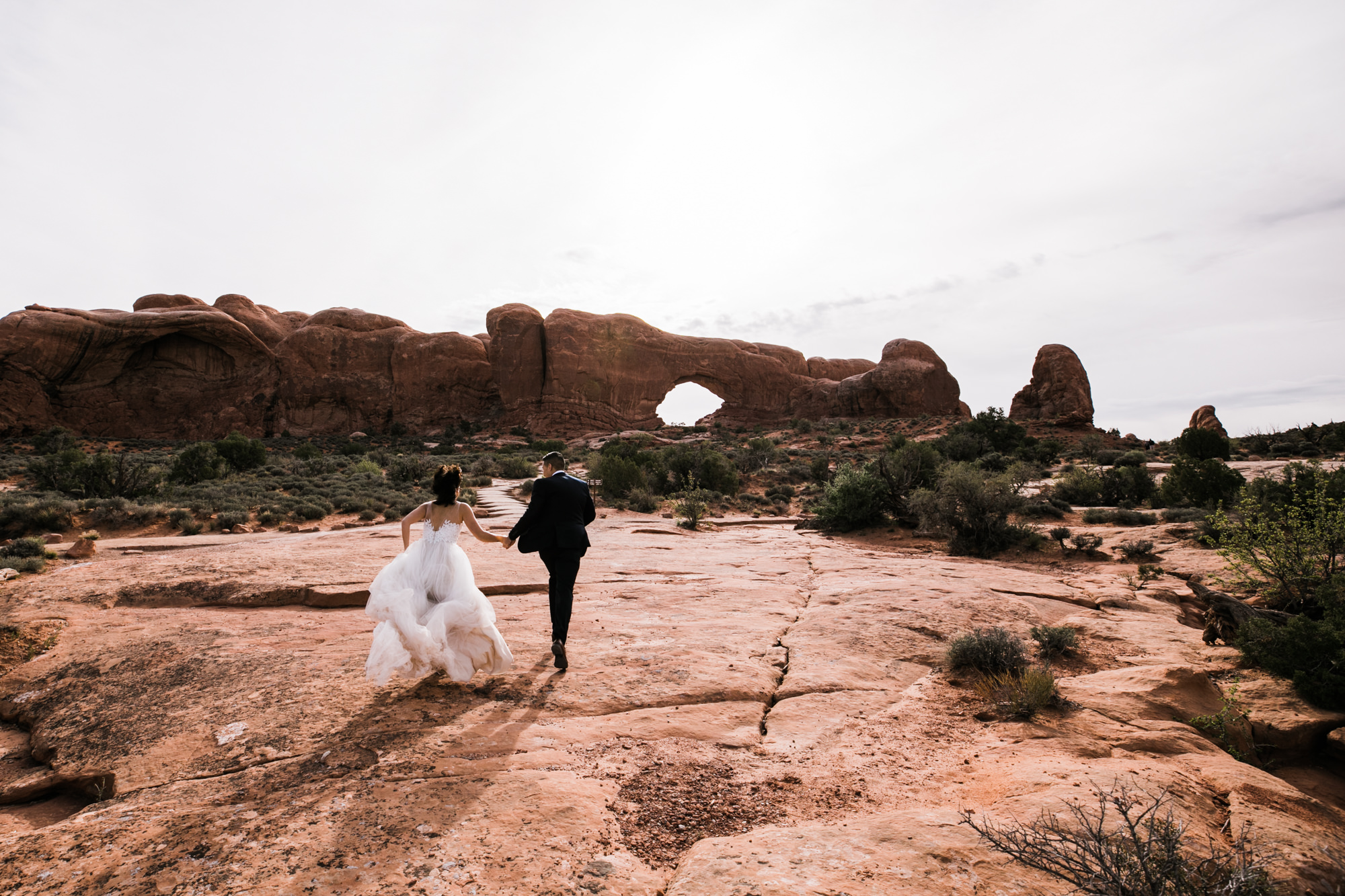 elopement first look in arches national park | desert elopement | moab wedding photographer | the hearnes adventure photography | www.thehearnes.com