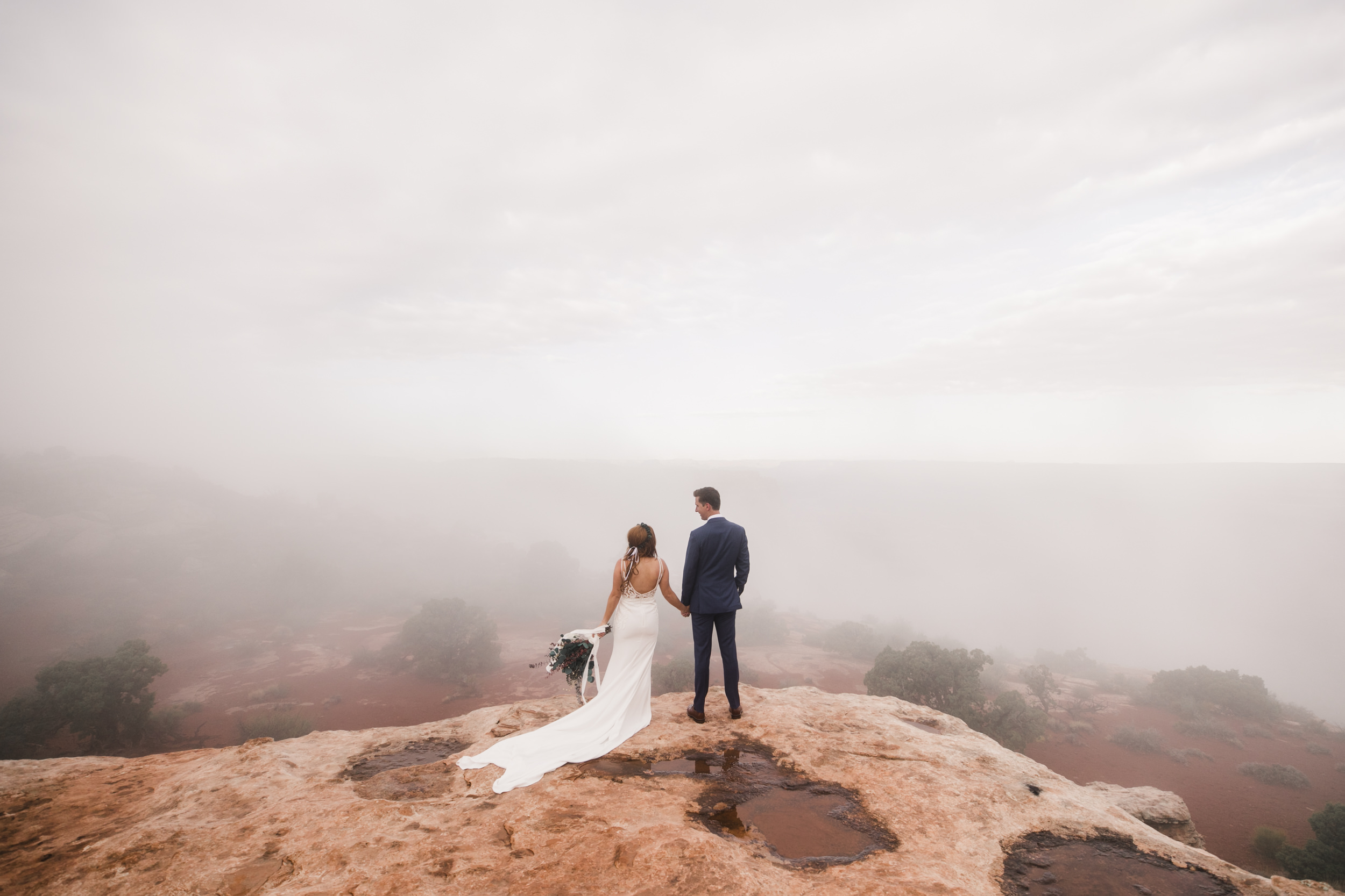 ben + rachelle's elopement in a secret canyon near Moab, Utah | canyonlands national park first look + portraits | secret ceremony on the edge of a cliff | moab adventure wedding photographer