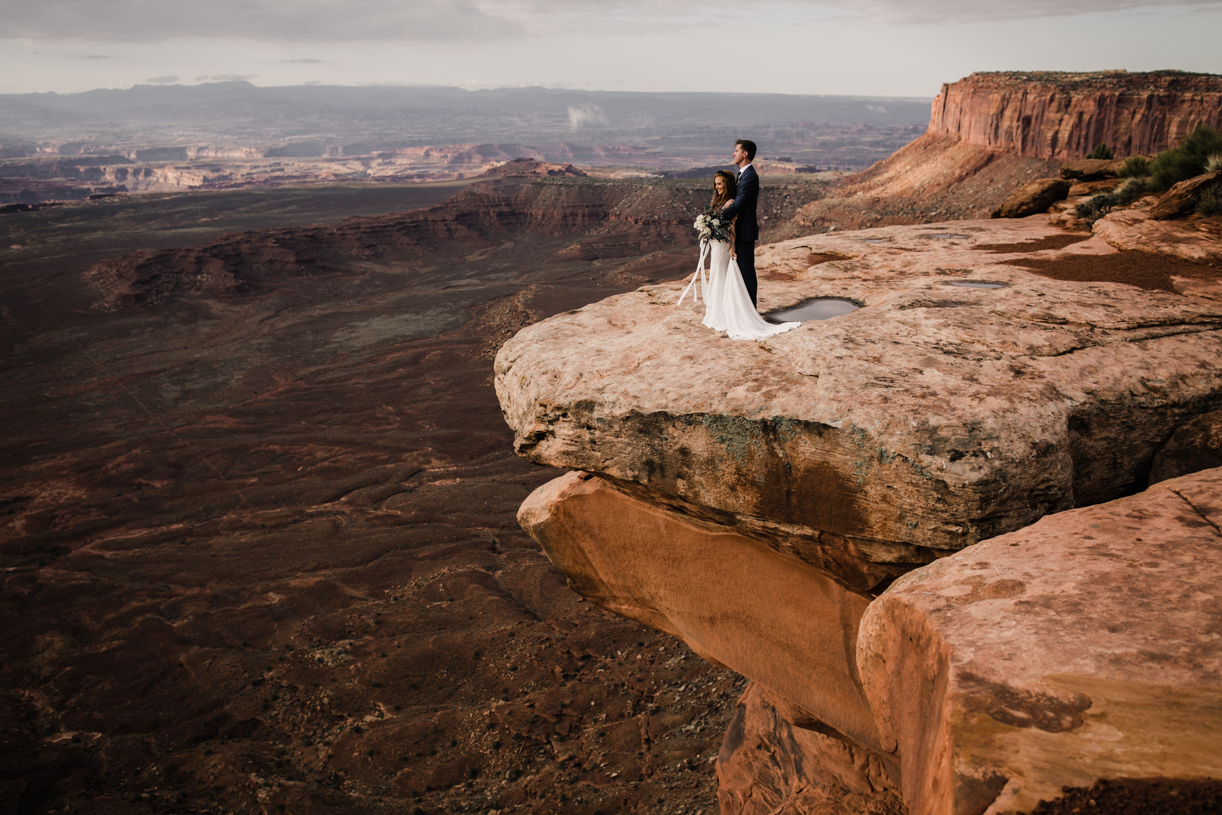 ben + rachelle's elopement in a secret canyon near Moab, Utah | canyonlands national park first look + portraits | secret ceremony on the edge of a cliff | moab adventure wedding photographer