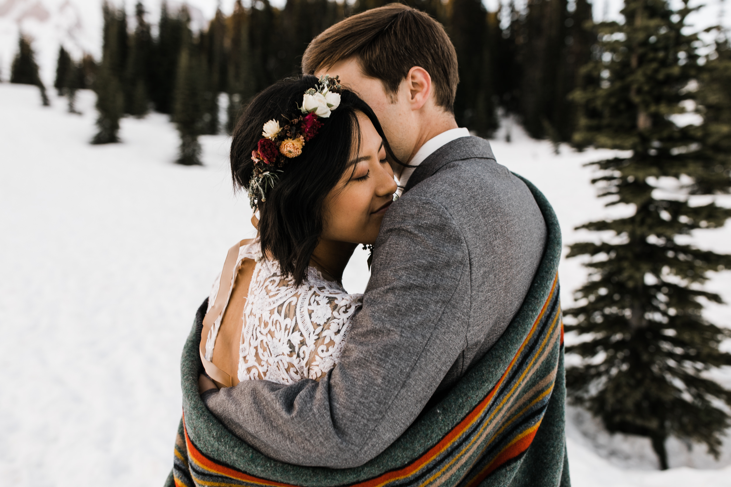 intimate wedding and reception in mount rainier national park | a frame cabin elopement first look | woodsy small reception in washington | snowy wedding portraits | elopement in the mountains