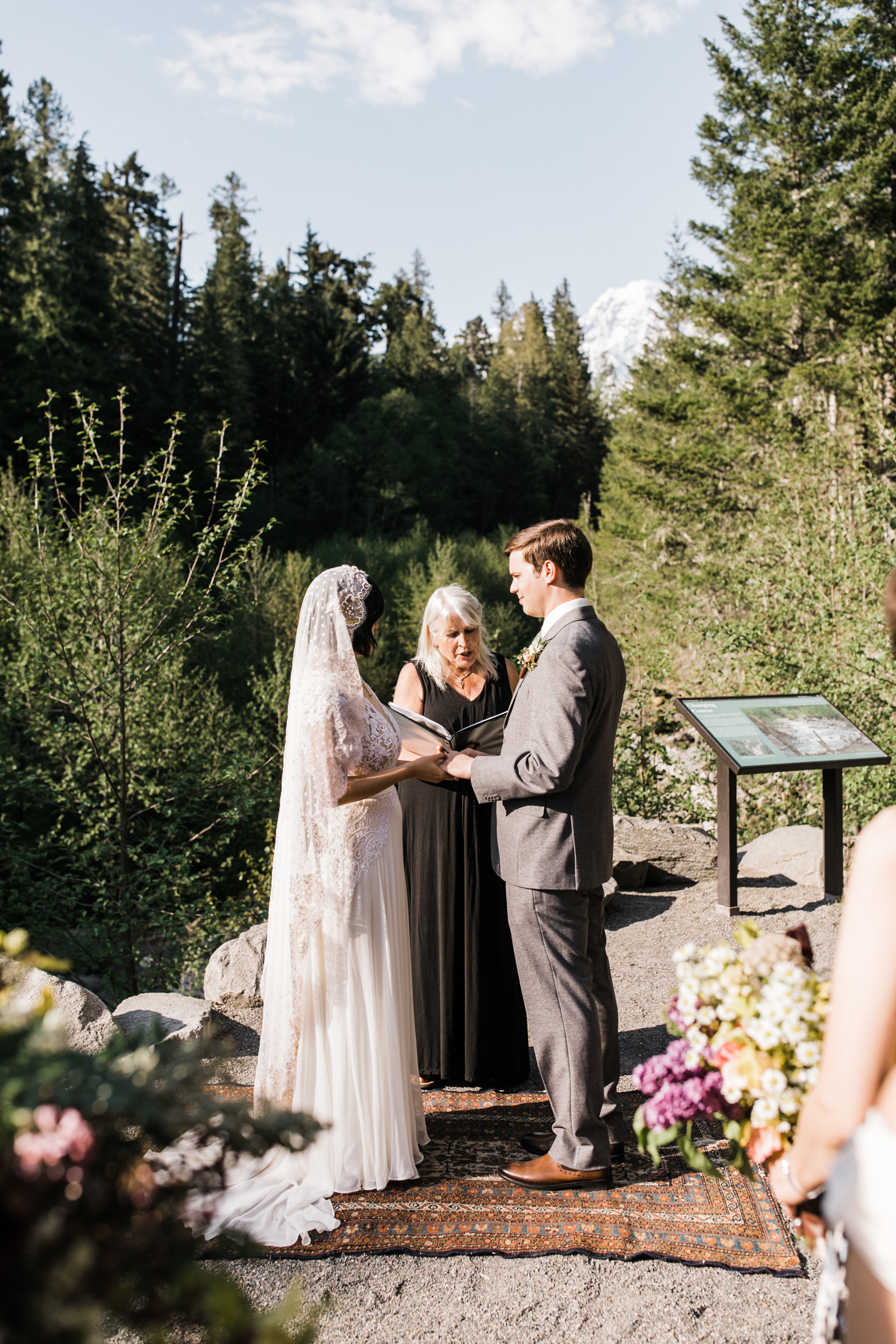 intimate wedding and reception in mount rainier national park | a frame cabin elopement first look | woodsy small reception in washington | snowy wedding portraits | elopement in the mountains