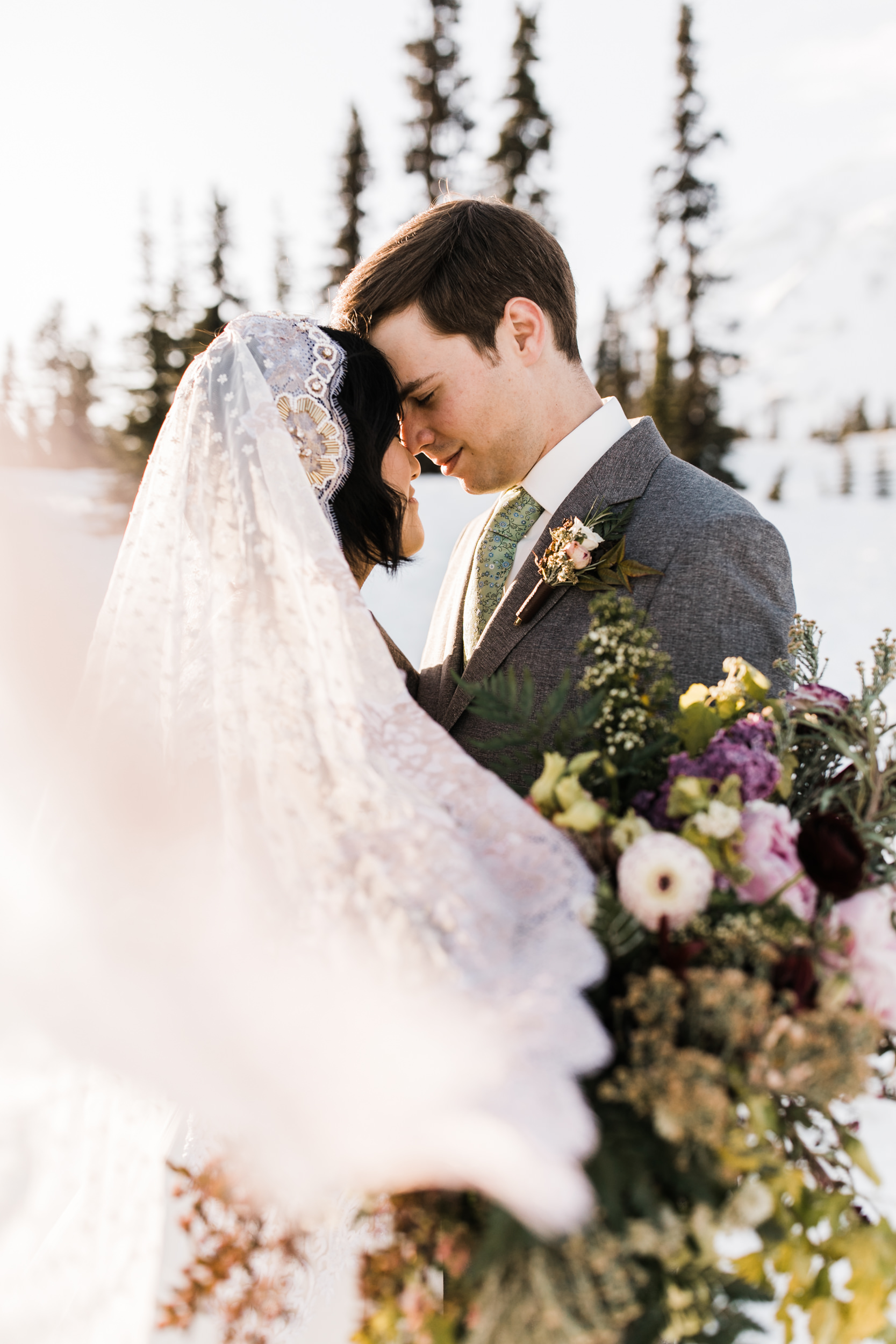 intimate wedding and reception in mount rainier national park | a frame cabin elopement first look | woodsy small reception in washington | snowy wedding portraits | elopement in the mountains