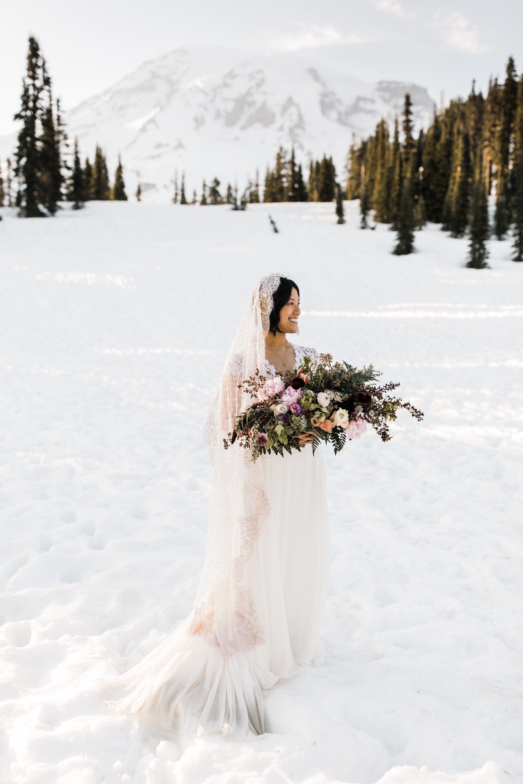 intimate wedding and reception in mount rainier national park | a frame cabin elopement first look | woodsy small reception in washington | snowy wedding portraits | elopement in the mountains