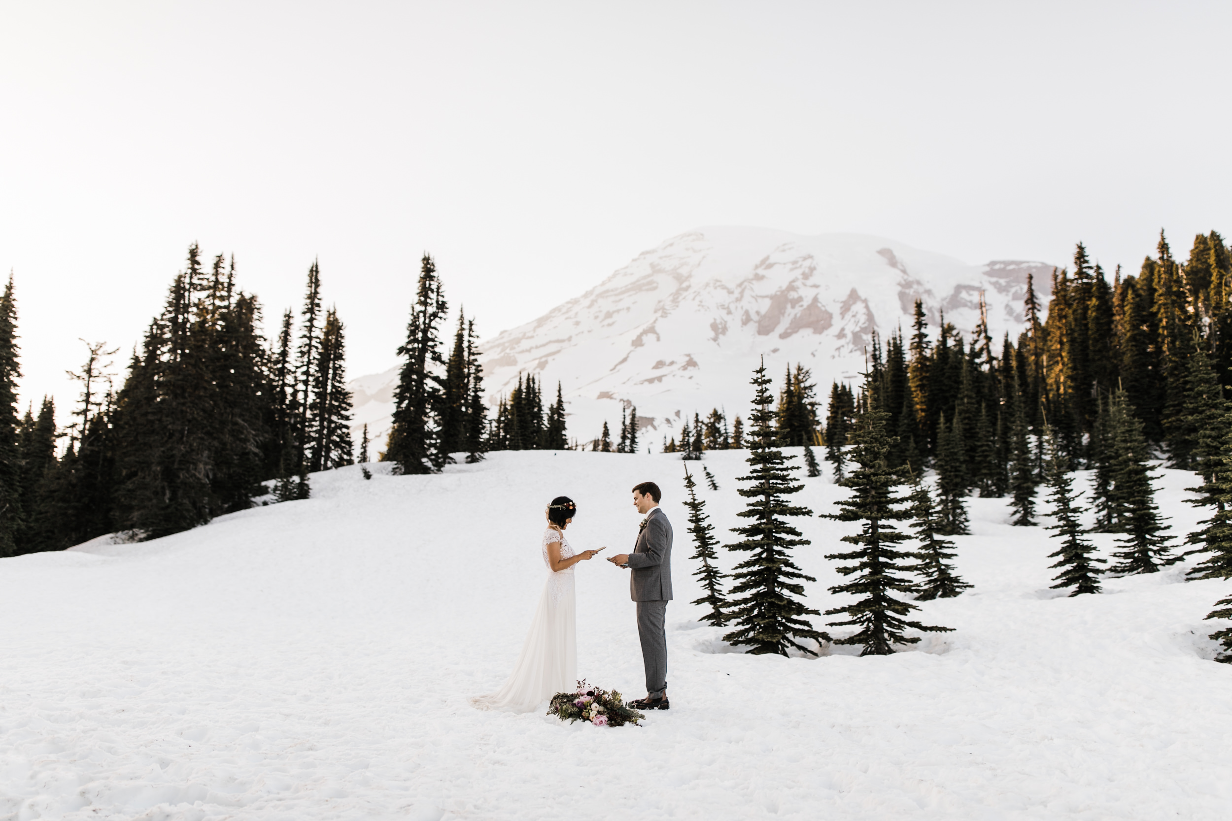 intimate wedding and reception in mount rainier national park | a frame cabin elopement first look | woodsy small reception in washington | snowy wedding portraits | elopement in the mountains