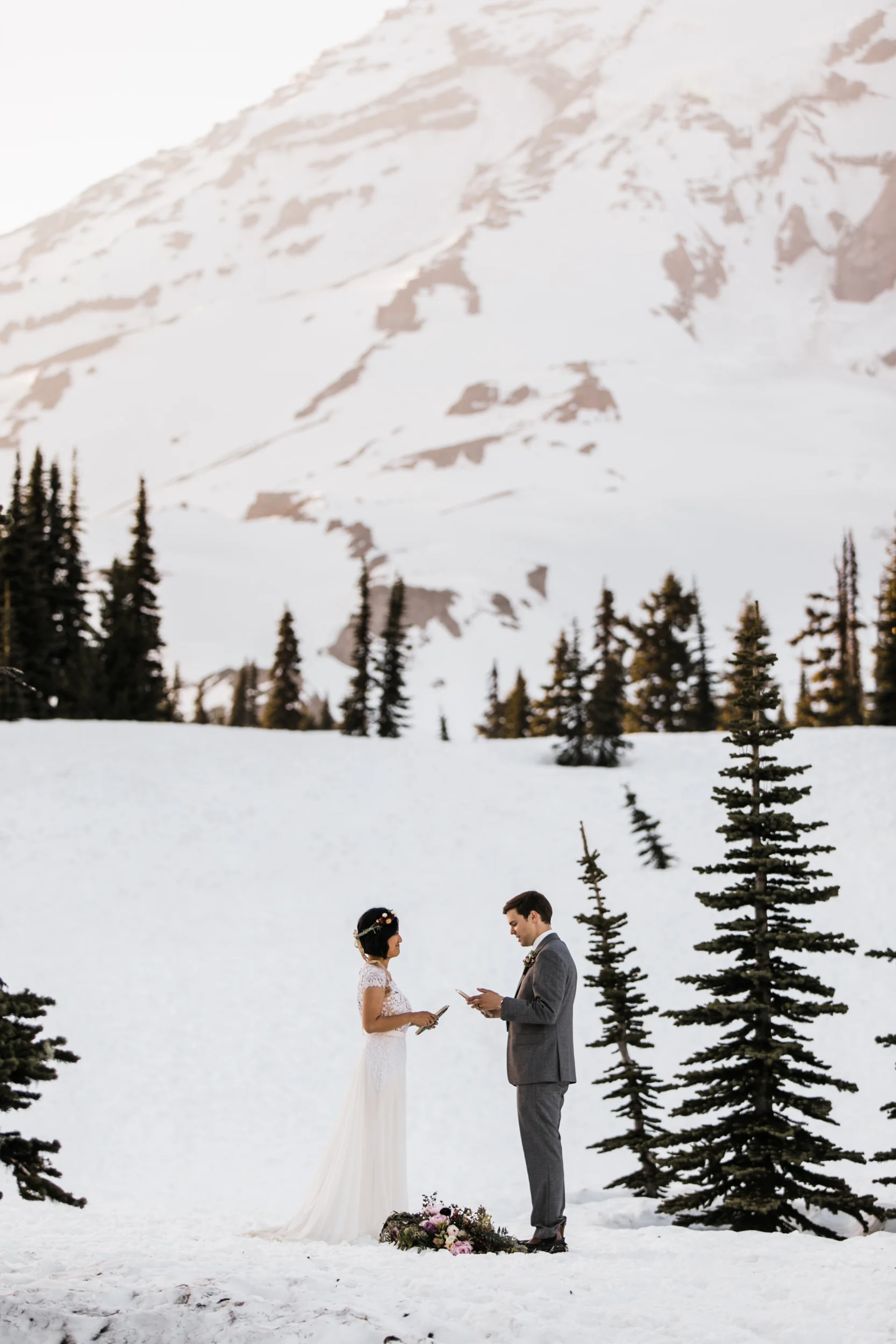 intimate wedding and reception in mount rainier national park | a frame cabin elopement first look | woodsy small reception in washington | snowy wedding portraits | elopement in the mountains