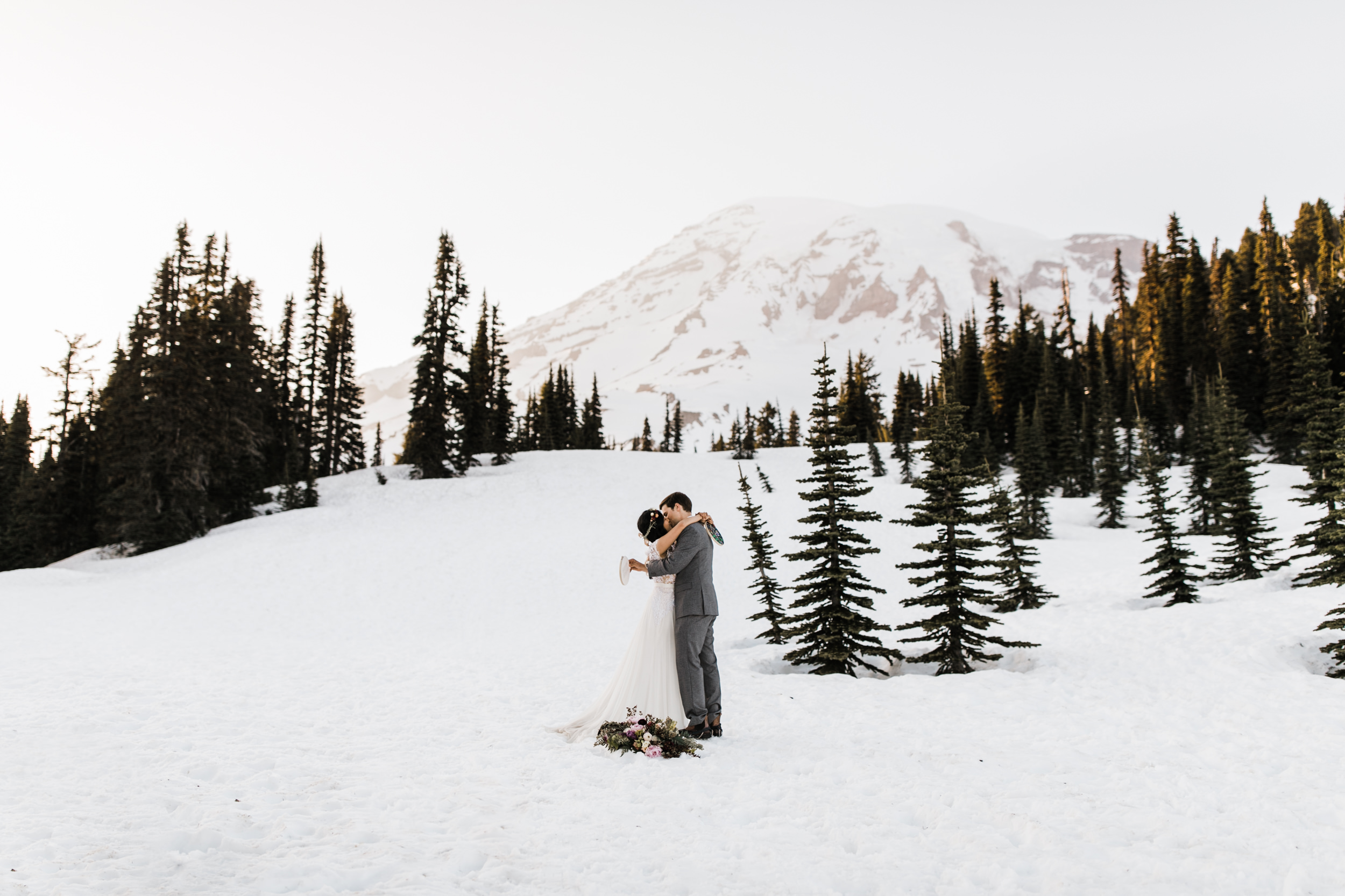 intimate wedding and reception in mount rainier national park | a frame cabin elopement first look | woodsy small reception in washington | snowy wedding portraits | elopement in the mountains