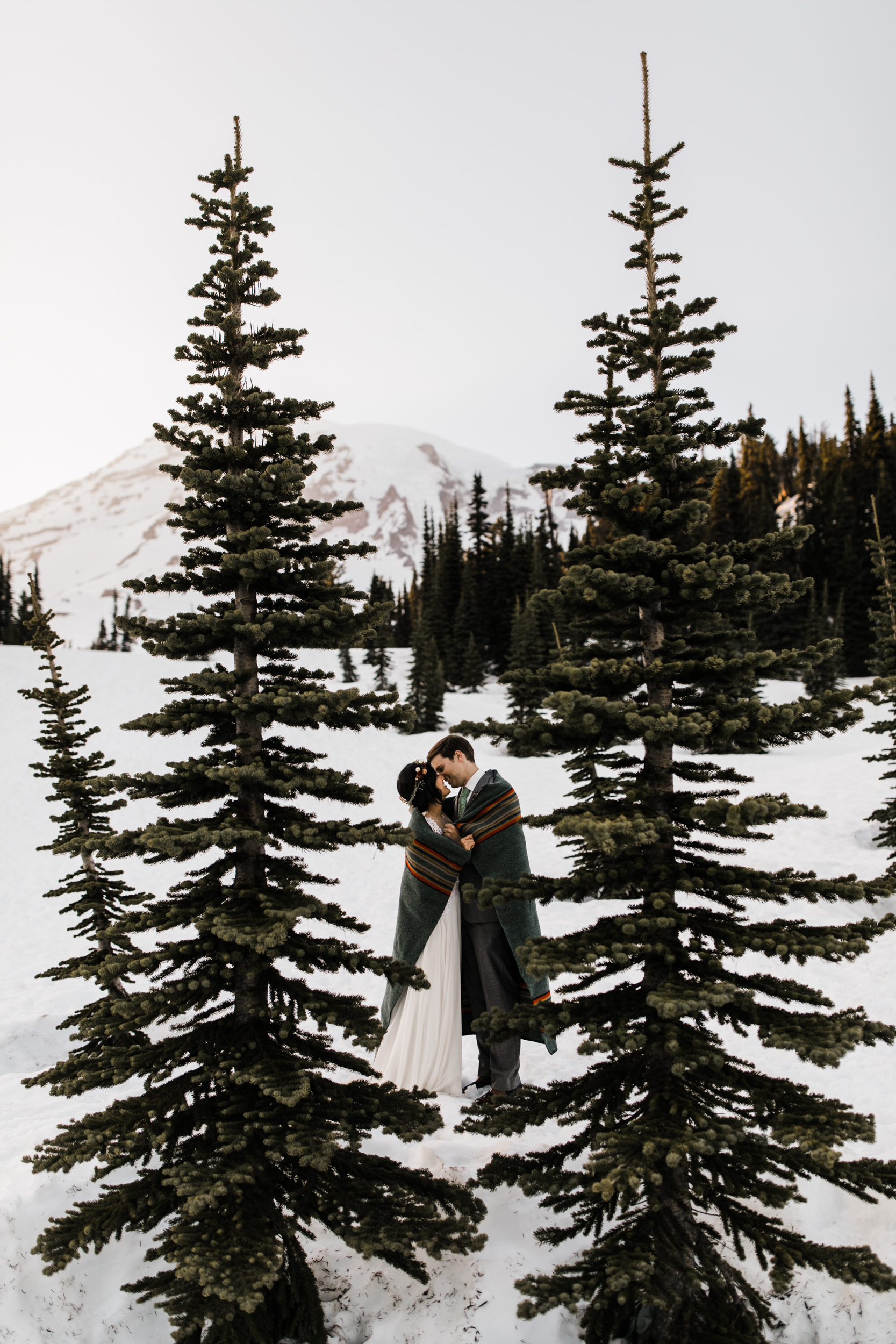 intimate wedding and reception in mount rainier national park | a frame cabin elopement first look | woodsy small reception in washington | snowy wedding portraits | elopement in the mountains