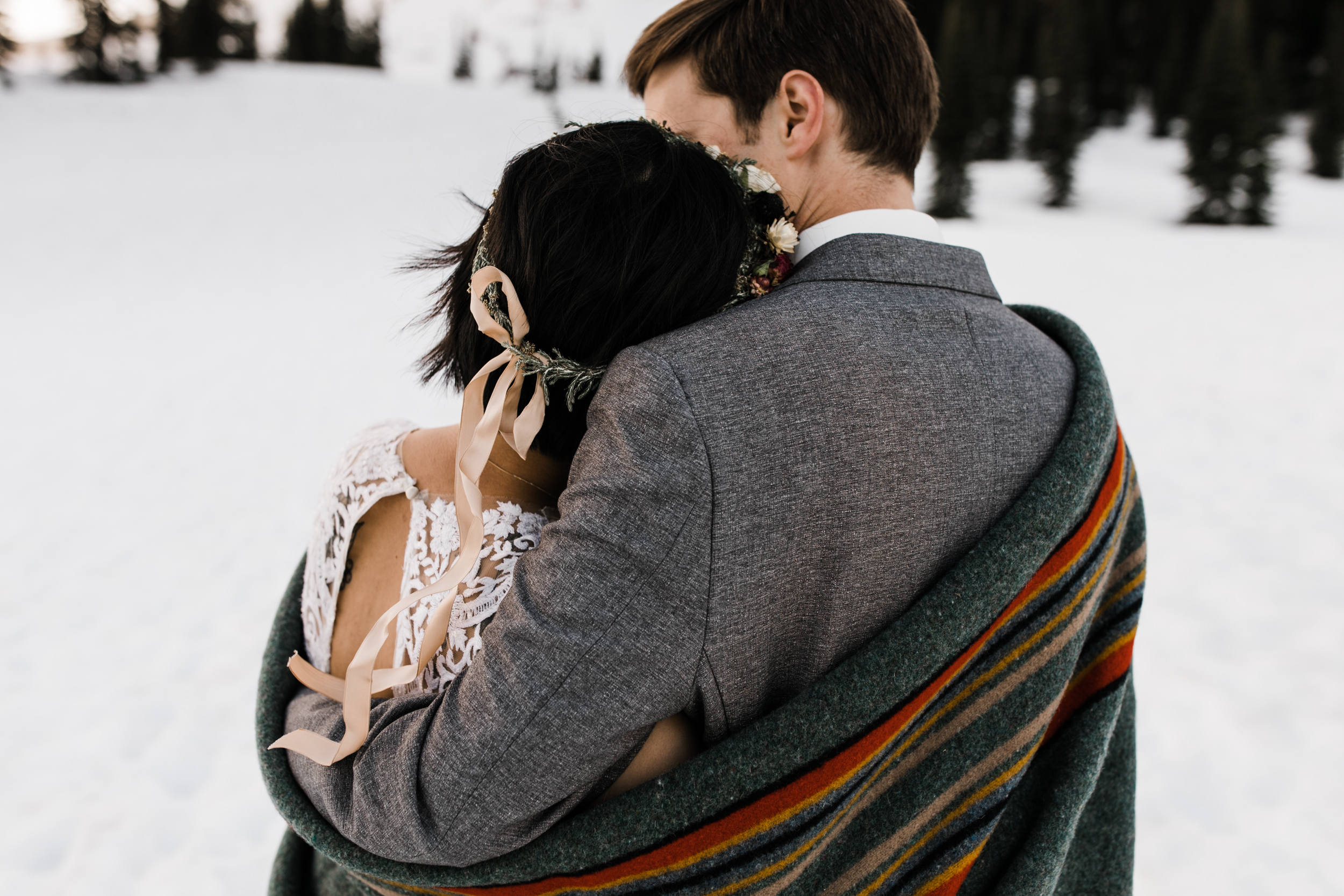 intimate wedding and reception in mount rainier national park | a frame cabin elopement first look | woodsy small reception in washington | snowy wedding portraits | elopement in the mountains