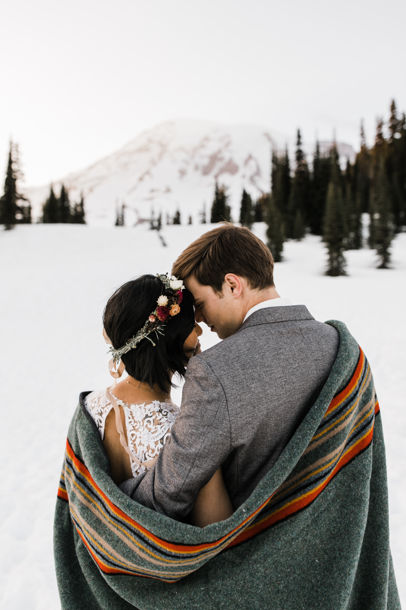 intimate wedding and reception in mount rainier national park | a frame cabin elopement first look | woodsy small reception in washington | snowy wedding portraits | elopement in the mountains