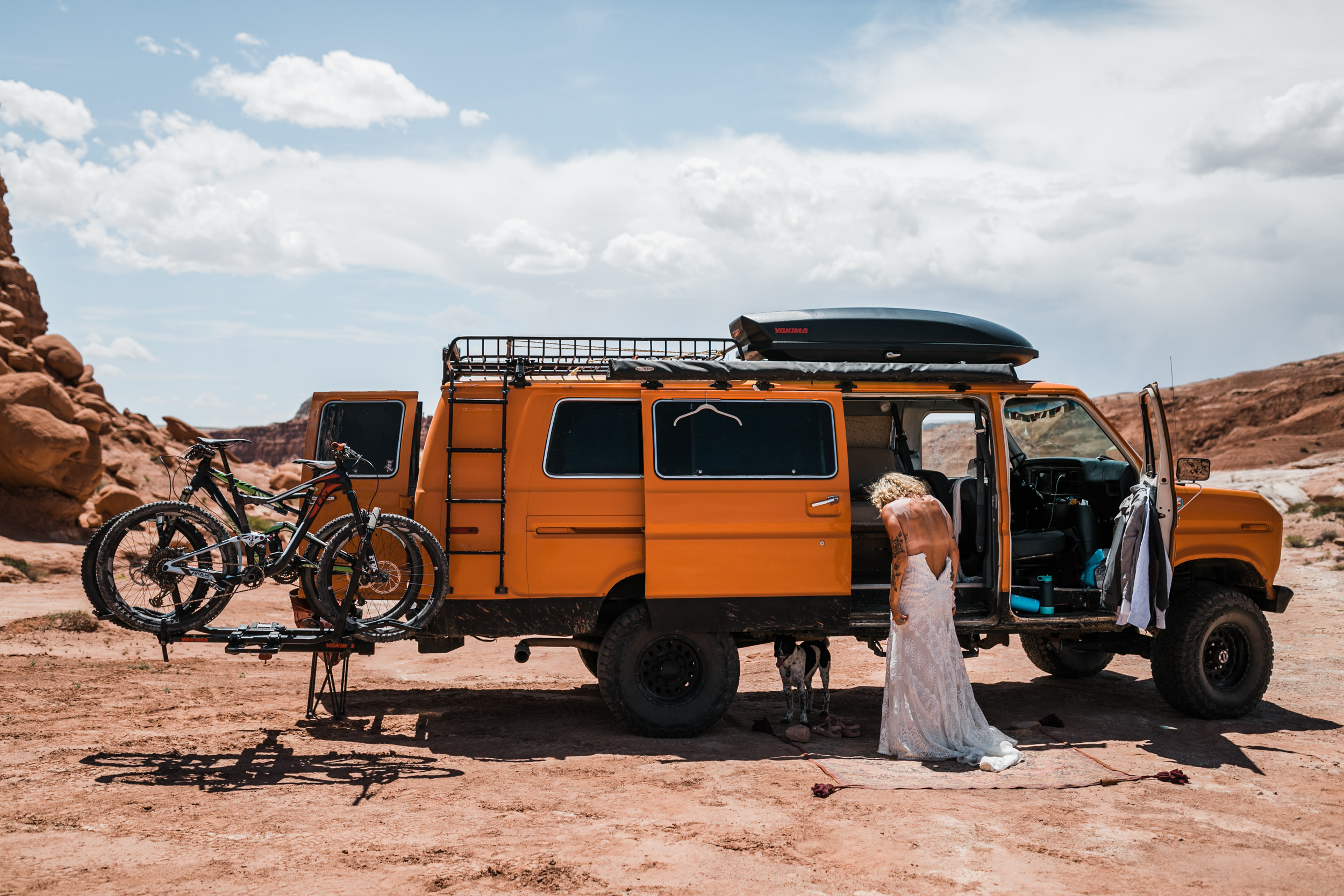 brianna madia getting ready for her elopement with her dogs bucket and dagwood in the utah desert