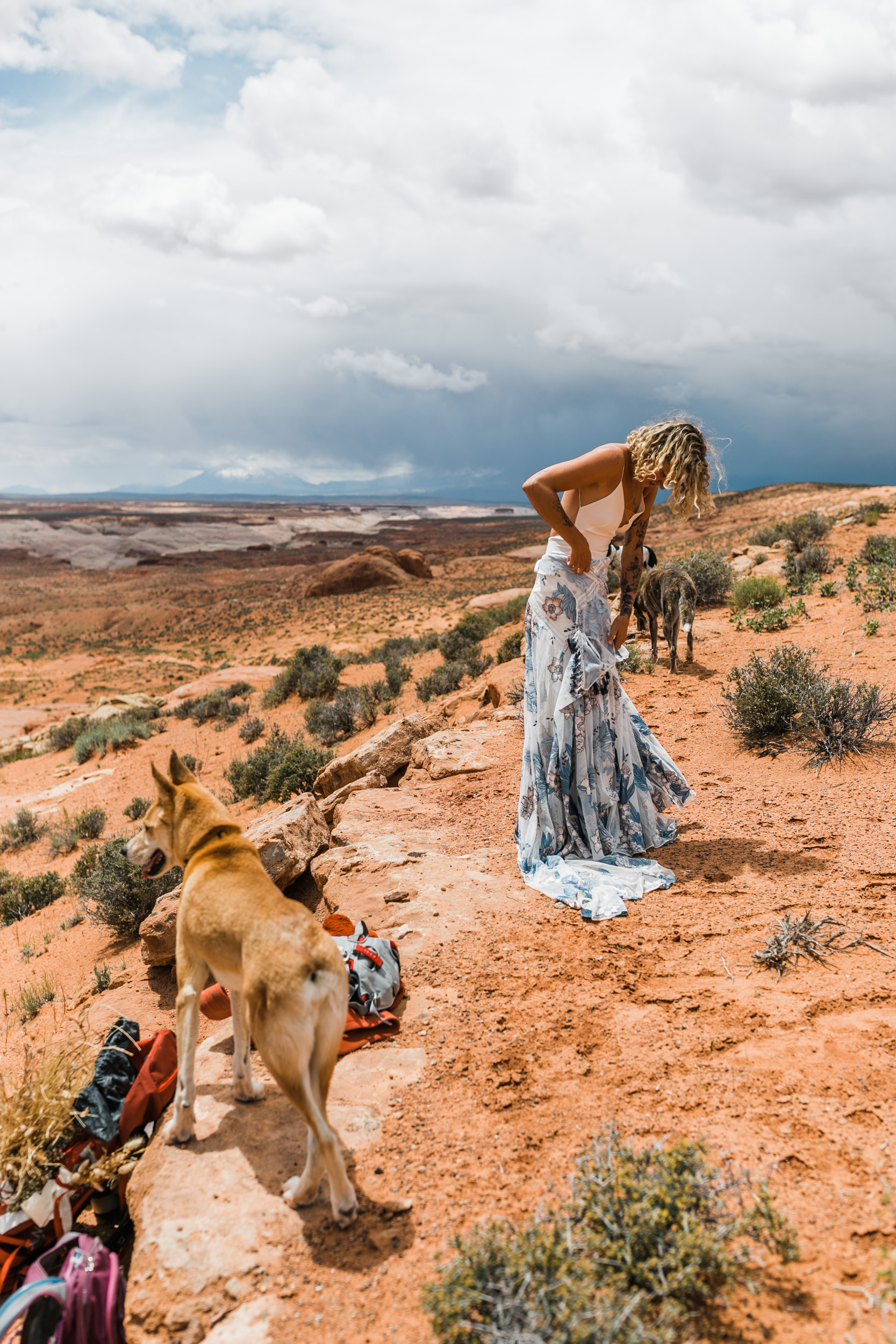 keith and brianna madia and their dogs bucket and dagwood in the utah desert | canyoneering adventure wedding | rue de seine aegean wedding gown in indigo