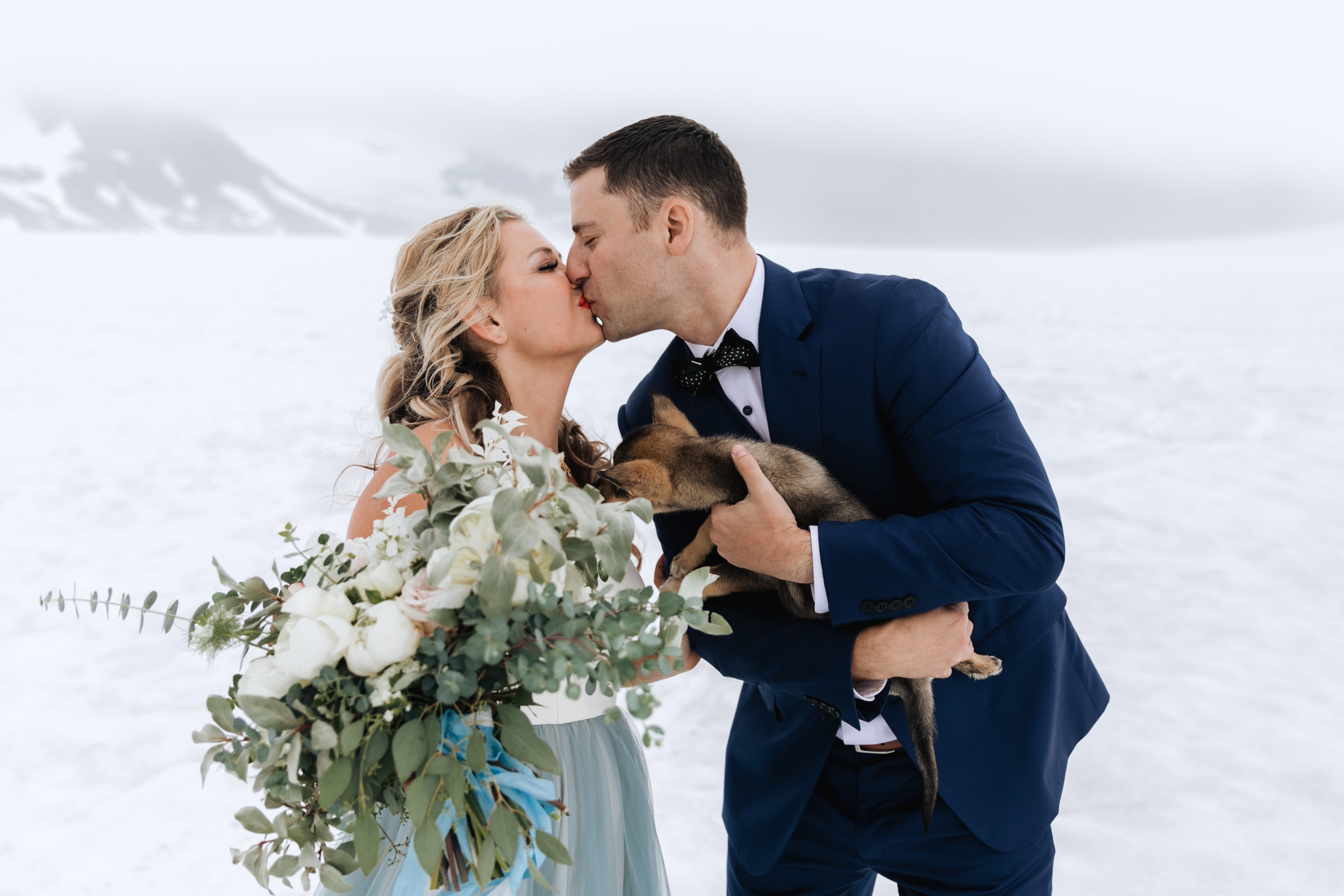 alaska destination wedding in seward | helicopter tour, dog sledding on a glacier | wedding day puppies | the hearnes adventure elopement photography