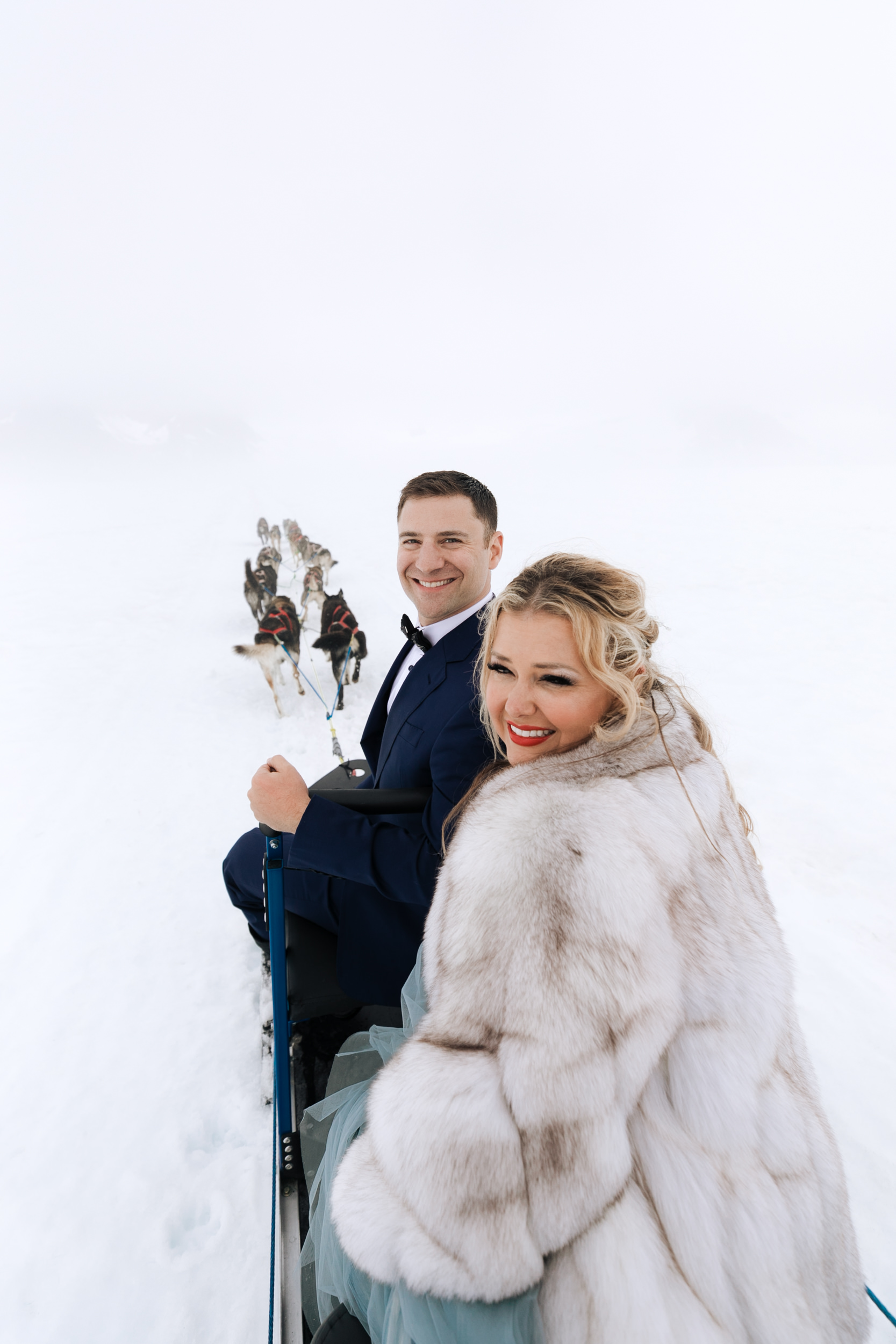 alaska destination wedding in seward | helicopter tour, dog sledding on a glacier | wedding day puppies | the hearnes adventure elopement photography