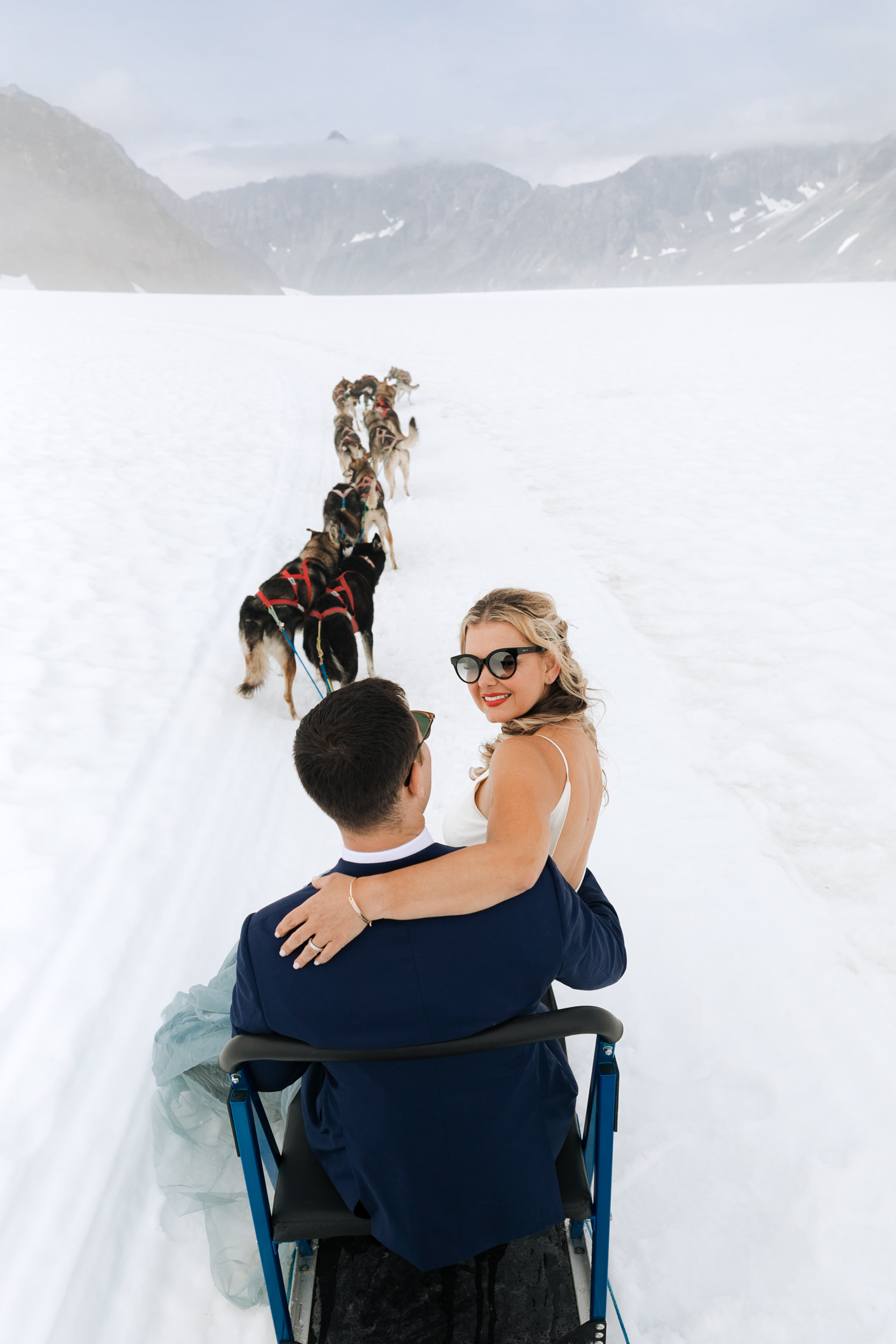 alaska destination wedding in seward | helicopter tour, dog sledding on a glacier | wedding day puppies | the hearnes adventure elopement photography