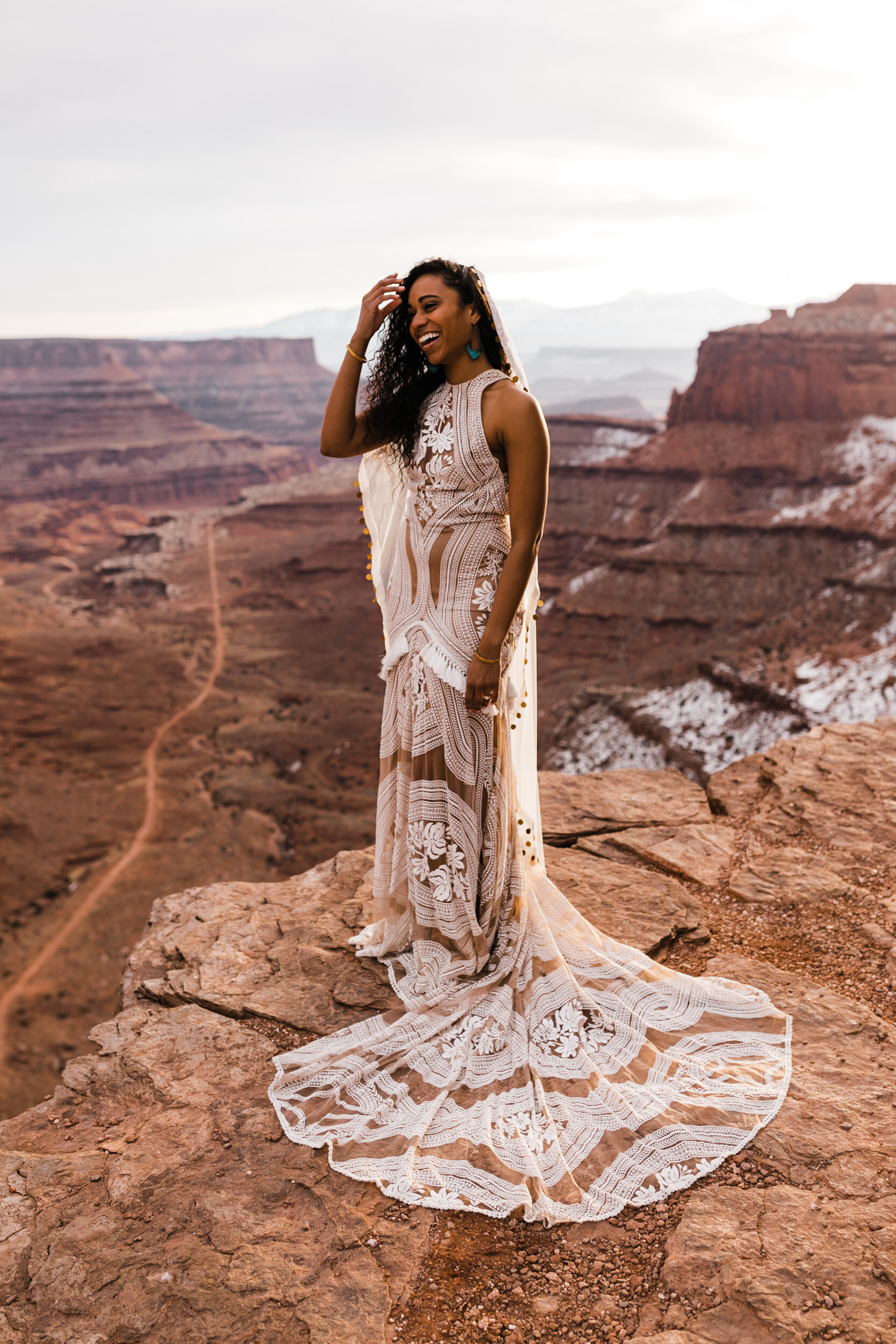 This Moab Elopement in Canyonlands National Park is major desert wedding inspiration! A surprise proposal at sunrise and Rue De Seine East Gown and Gold Coin Veil by The Hearnes Adventure Photography
