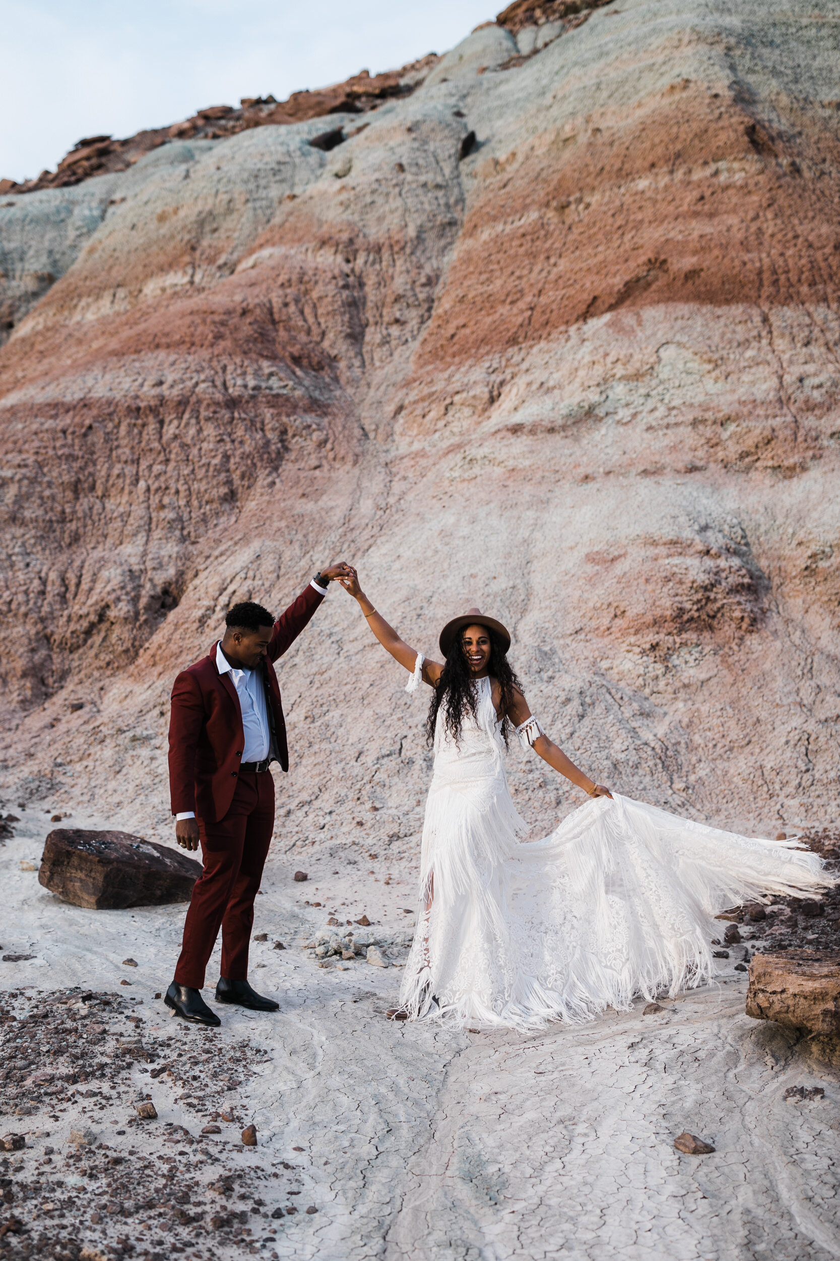 Moab Elopement Photographer | The Hearnes | Rue de Seine Dallas Gown | Bohemian Bride Fringe Wedding Dress &amp; Groom’s Burgundy Suit