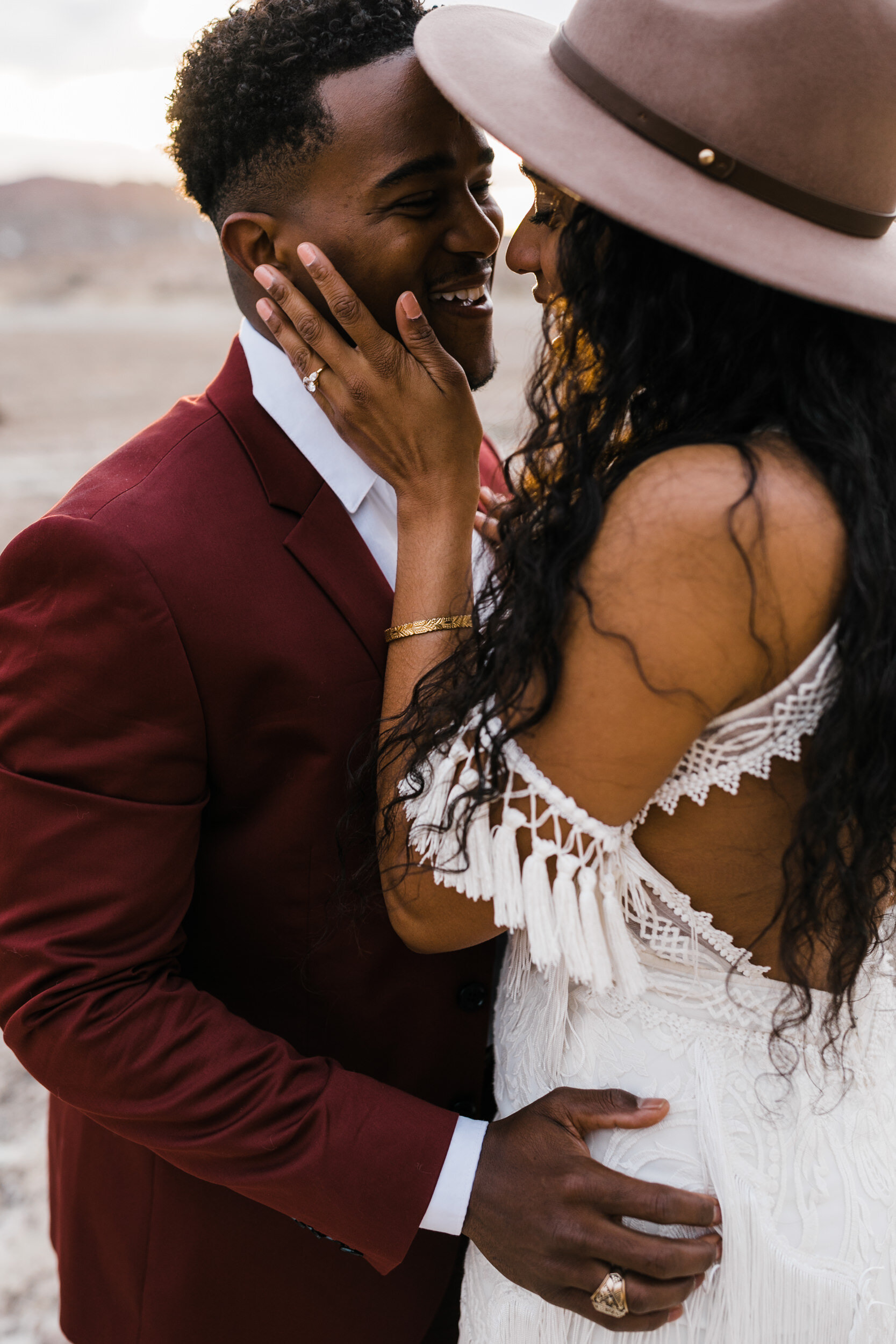 Moab Elopement Photographer | The Hearnes | Rue de Seine Dallas Gown | Bohemian Bride Fringe Wedding Dress &amp; Groom’s Burgundy Suit