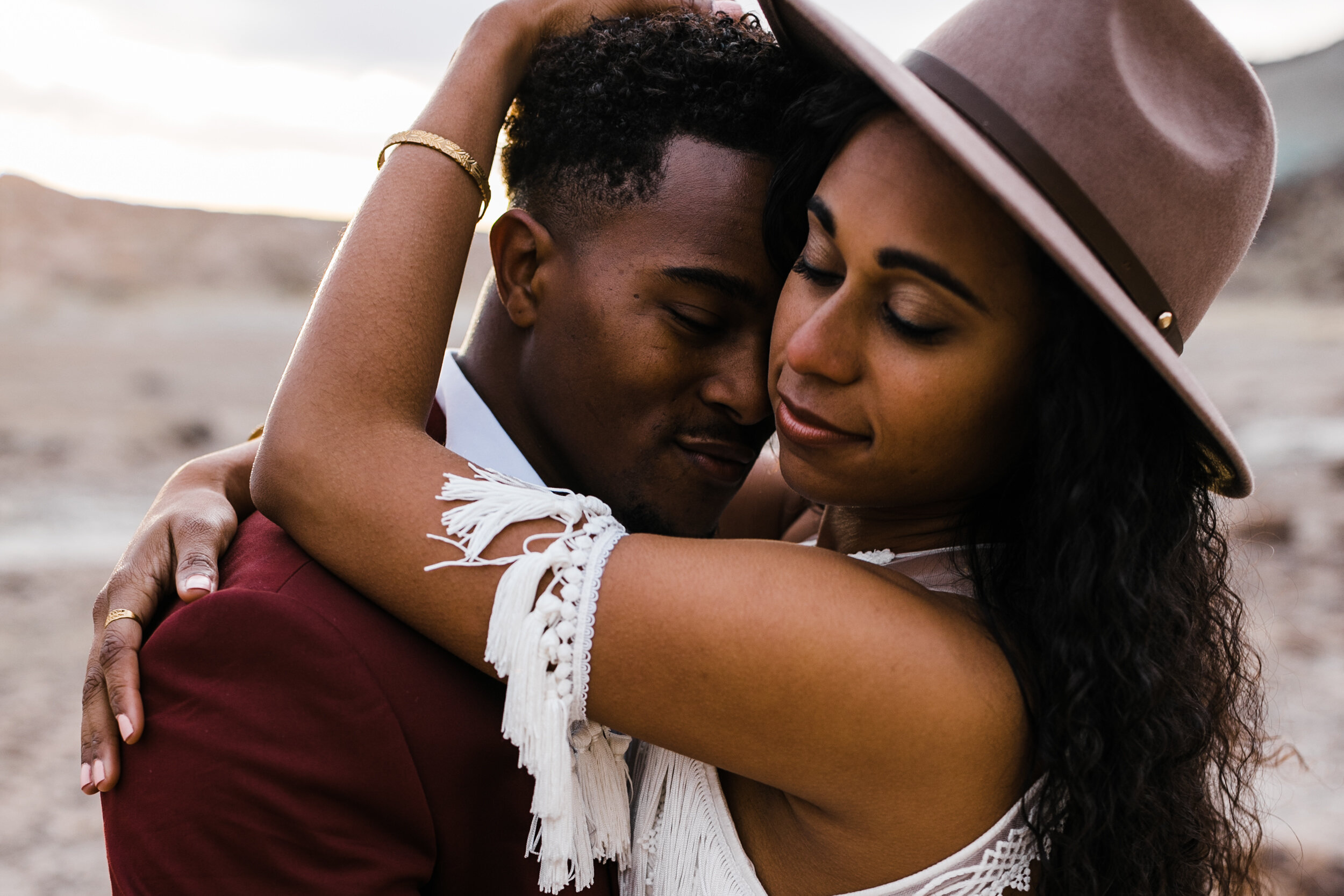 Moab Elopement Photographer | The Hearnes | Rue de Seine Dallas Gown | Bohemian Bride Fringe Wedding Dress &amp; Groom’s Burgundy Suit