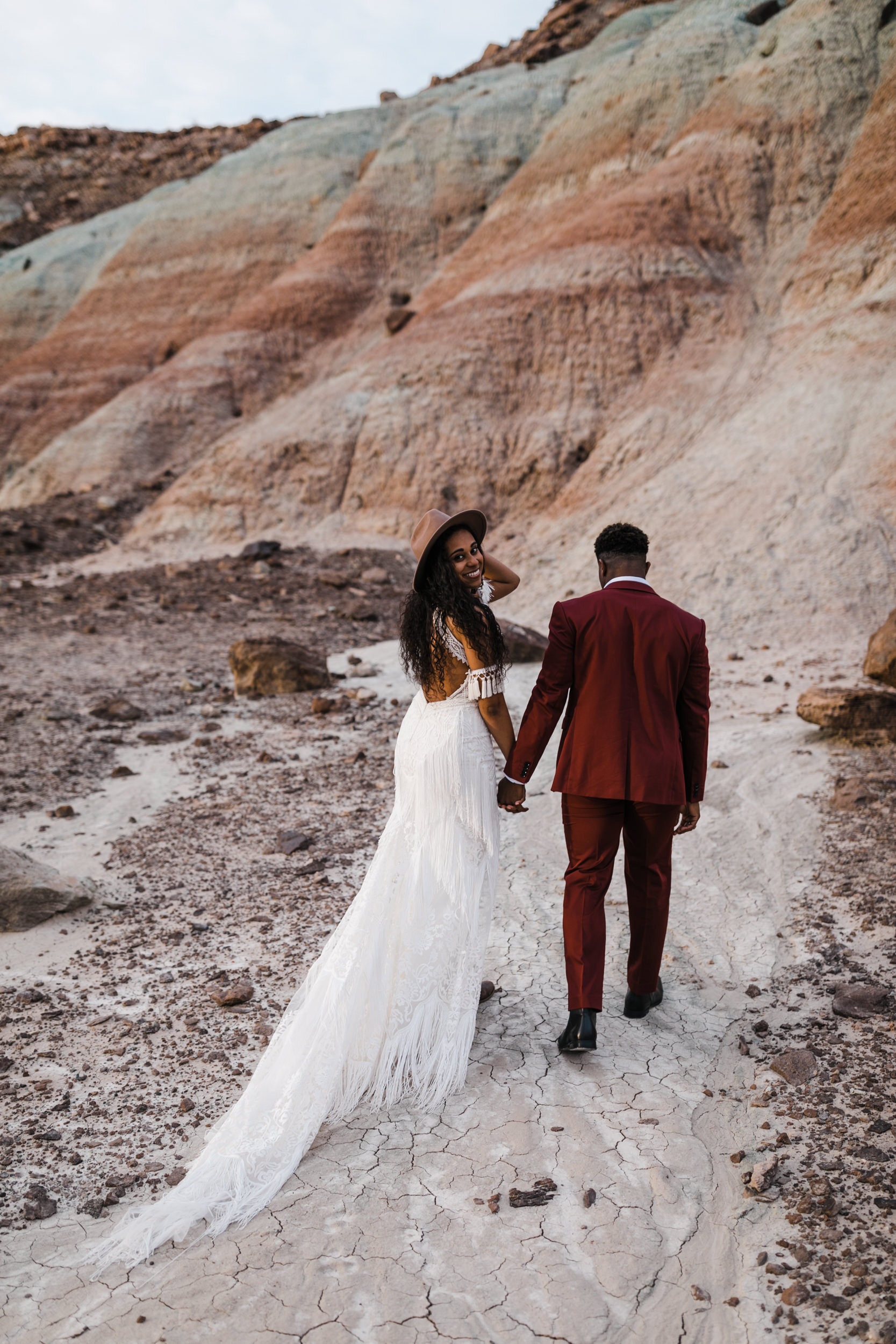 Moab Elopement Photographer | The Hearnes | Rue de Seine Dallas Gown | Bohemian Bride Fringe Wedding Dress &amp; Groom’s Burgundy Suit