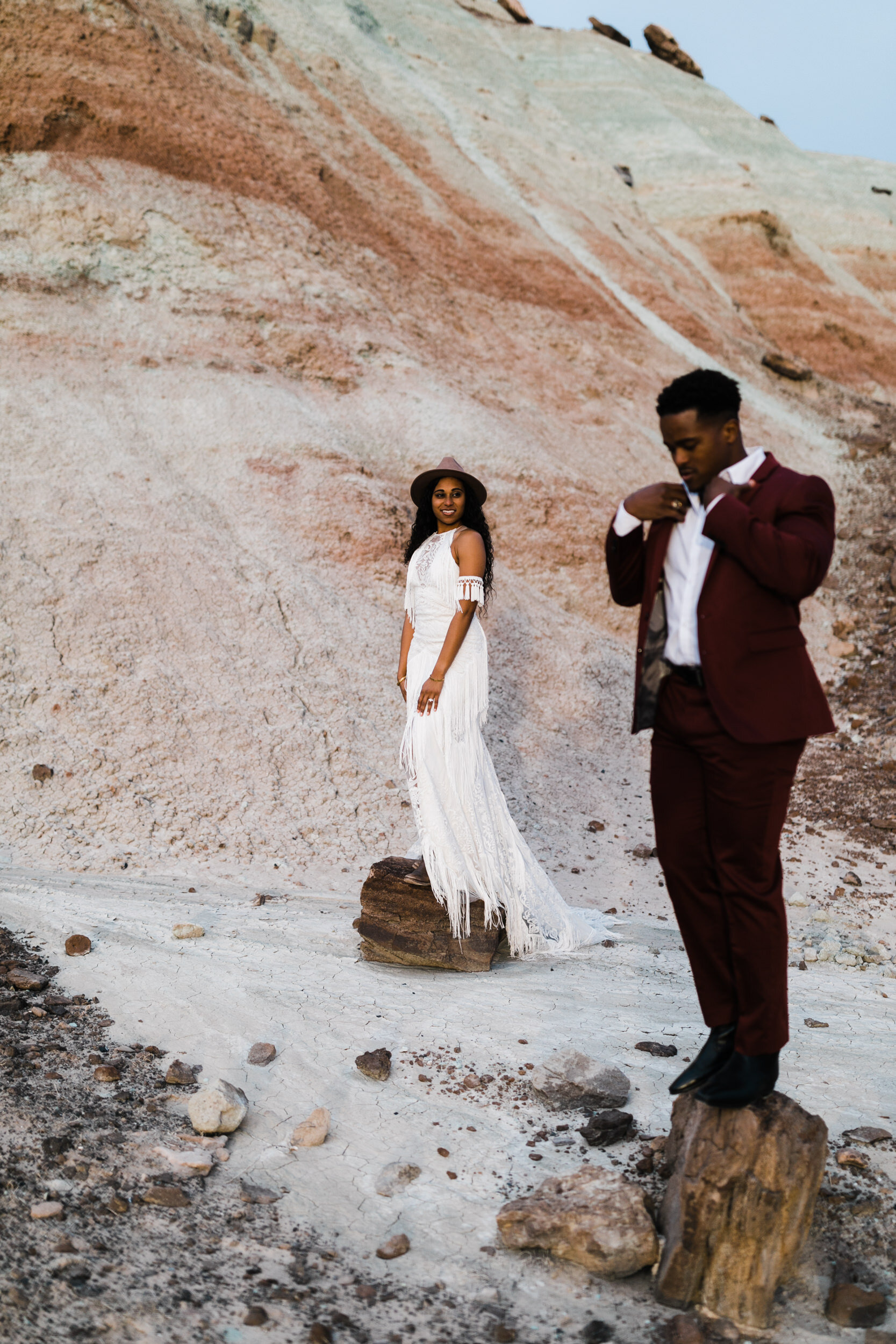 Moab Elopement Photographer | The Hearnes | Rue de Seine Dallas Gown | Bohemian Bride Fringe Wedding Dress &amp; Groom’s Burgundy Suit