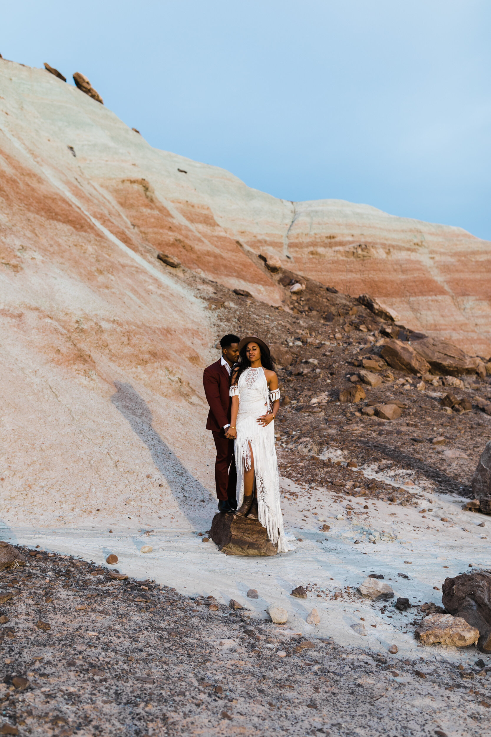 Moab Elopement Photographer | The Hearnes | Rue de Seine Dallas Gown | Bohemian Bride Fringe Wedding Dress &amp; Groom’s Burgundy Suit