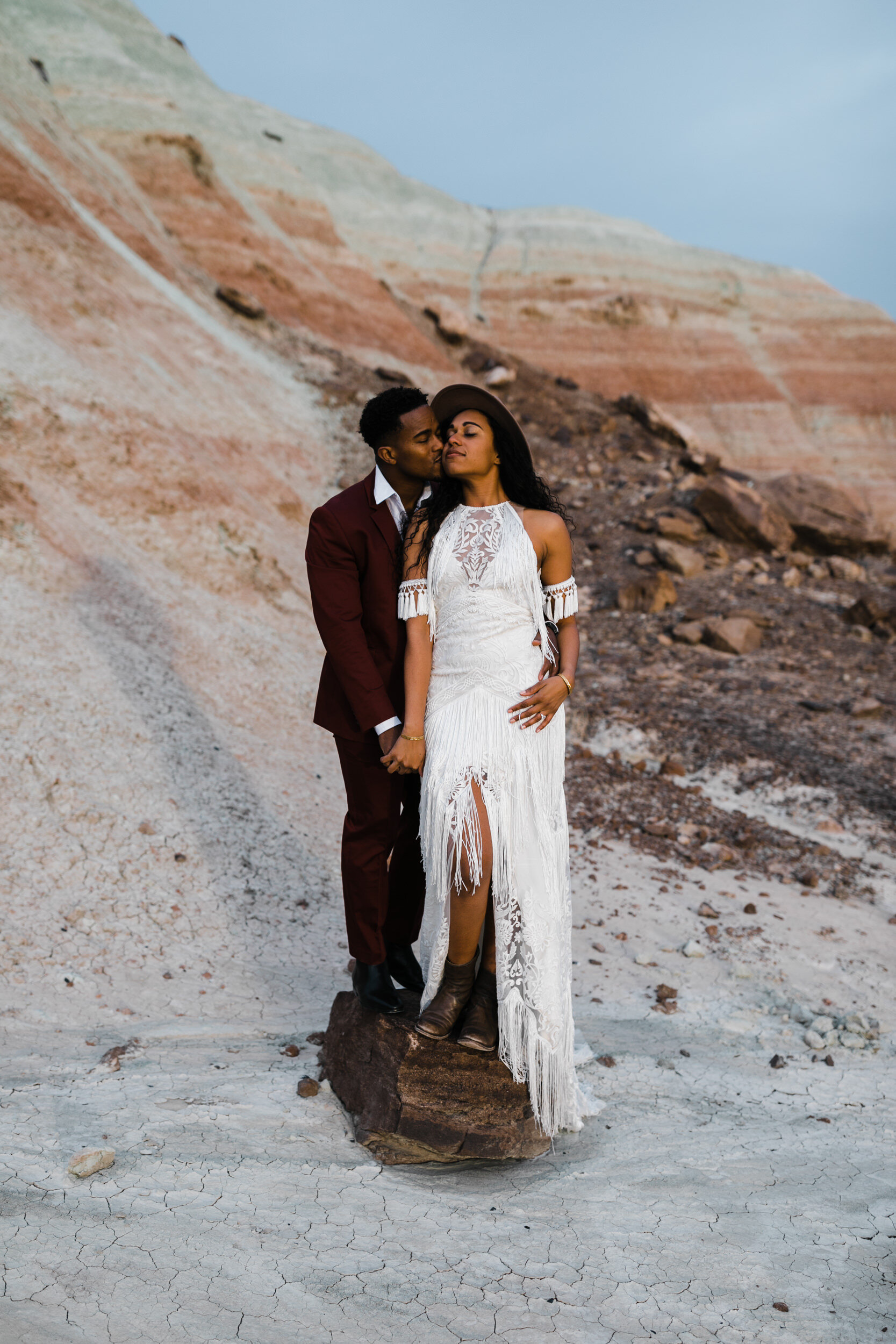 Moab Elopement Photographer | The Hearnes | Rue de Seine Dallas Gown | Bohemian Bride Fringe Wedding Dress &amp; Groom’s Burgundy Suit