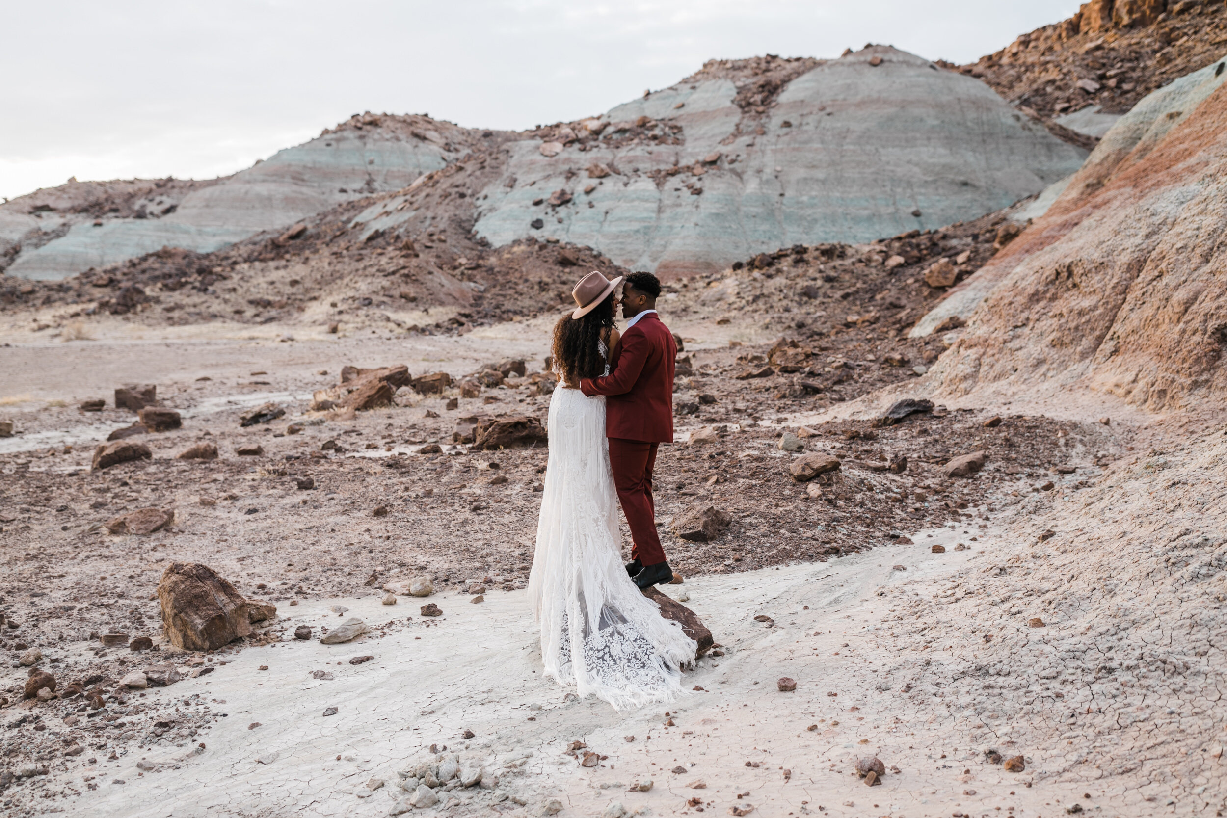 Moab Elopement Photographer | The Hearnes | Rue de Seine Dallas Gown | Bohemian Bride Fringe Wedding Dress &amp; Groom’s Burgundy Suit