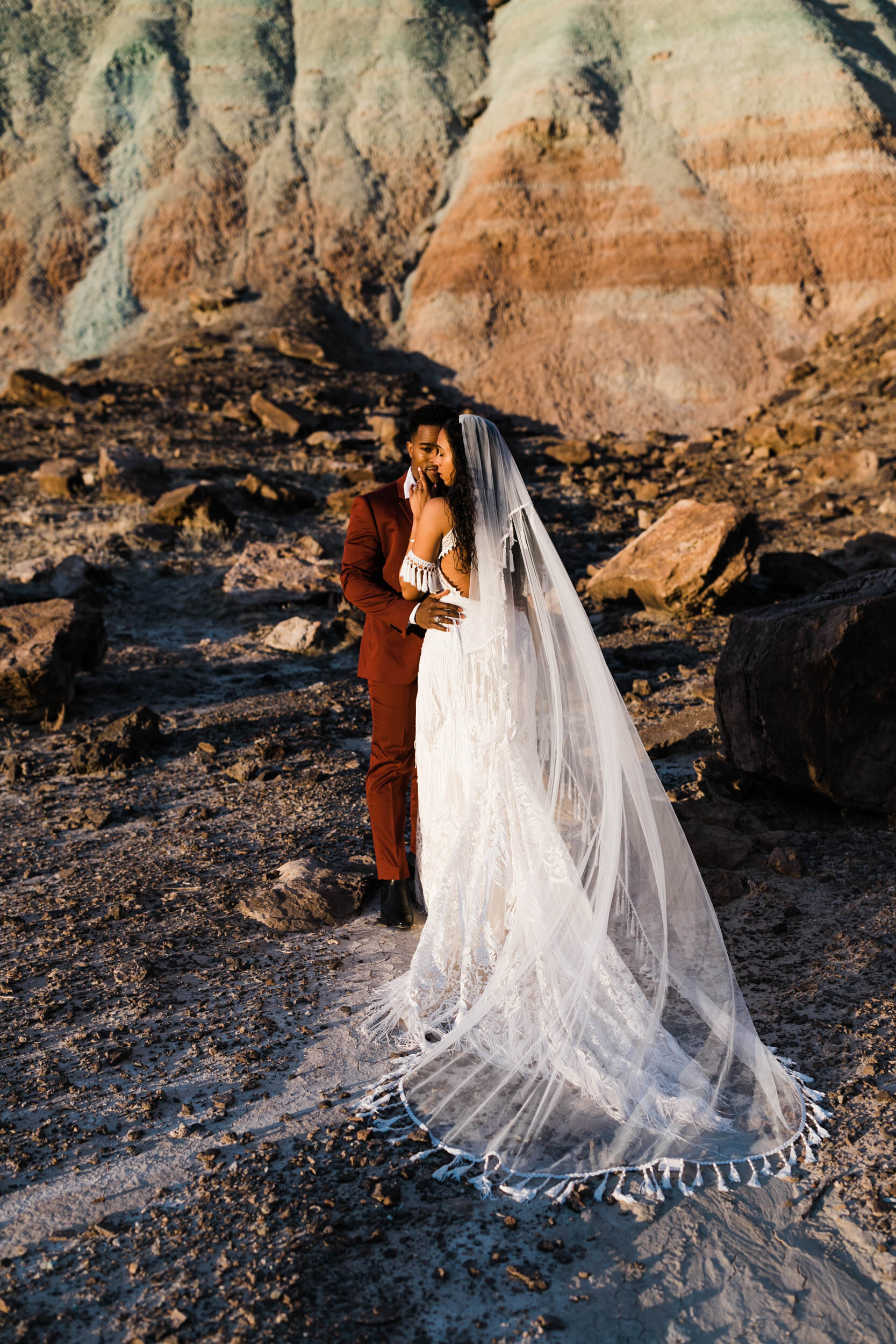 Moab Elopement Photographer | The Hearnes | Rue de Seine Dallas Gown | Bohemian Bride Fringe Wedding Dress &amp; Groom’s Burgundy Suit