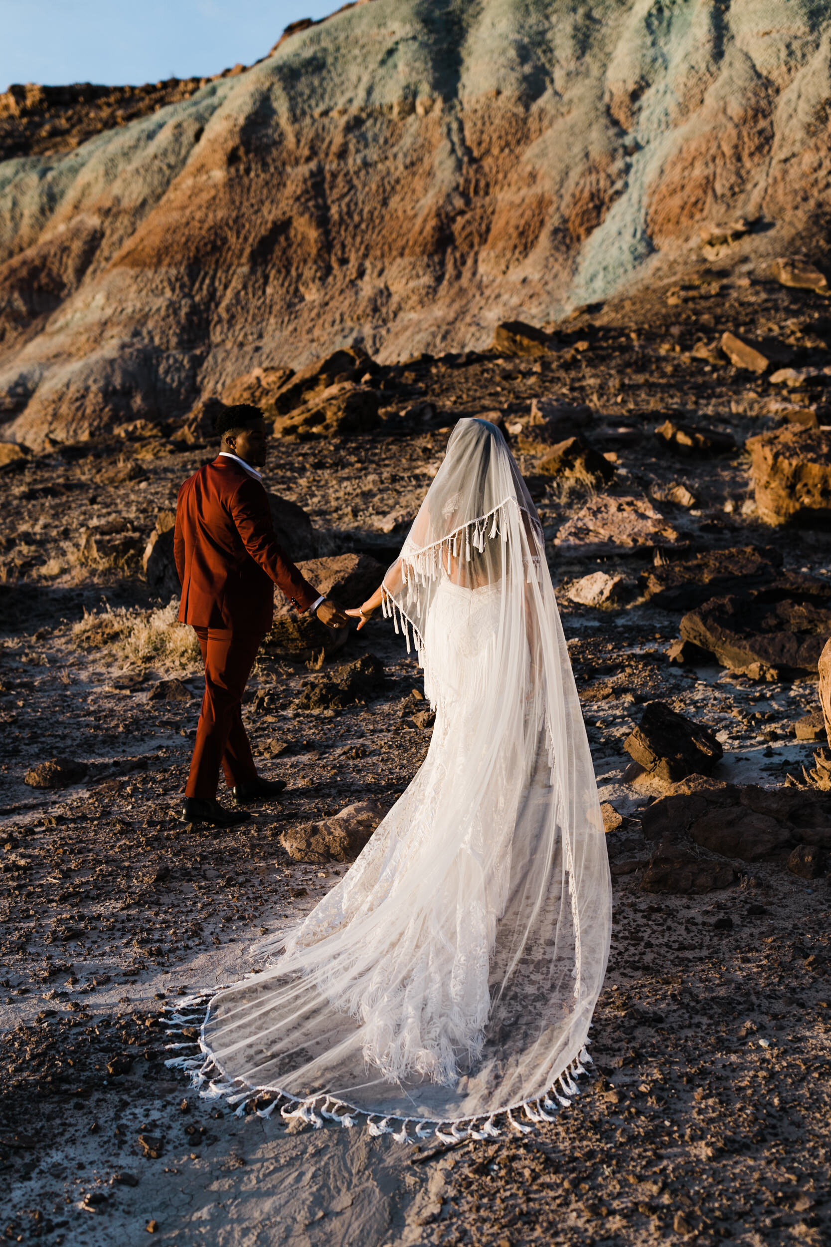 Moab Elopement Photographer | The Hearnes | Rue de Seine Dallas Gown | Bohemian Bride Fringe Wedding Dress &amp; Groom’s Burgundy Suit