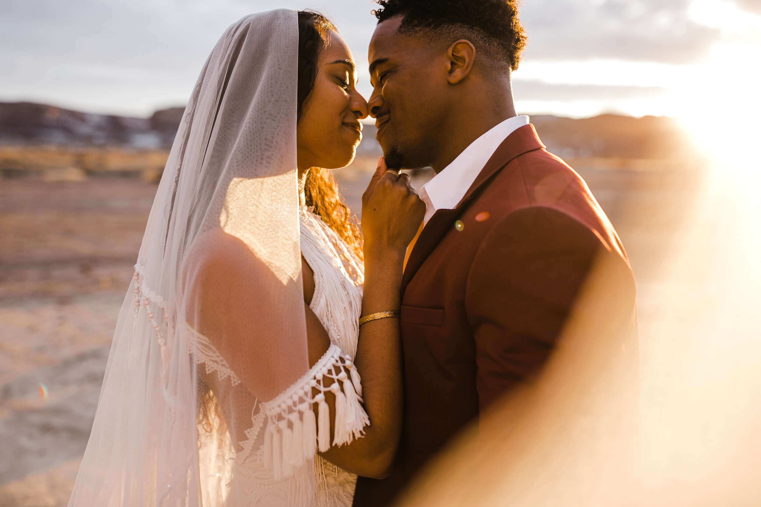 Moab Elopement Photographer | The Hearnes | Rue de Seine Dallas Gown | Bohemian Bride Fringe Wedding Dress &amp; Groom’s Burgundy Suit