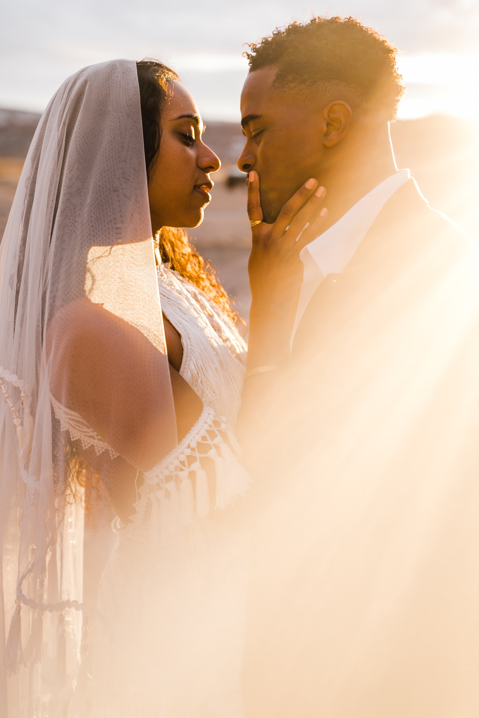 Moab Elopement Photographer | The Hearnes | Rue de Seine Dallas Gown | Bohemian Bride Fringe Wedding Dress &amp; Groom’s Burgundy Suit