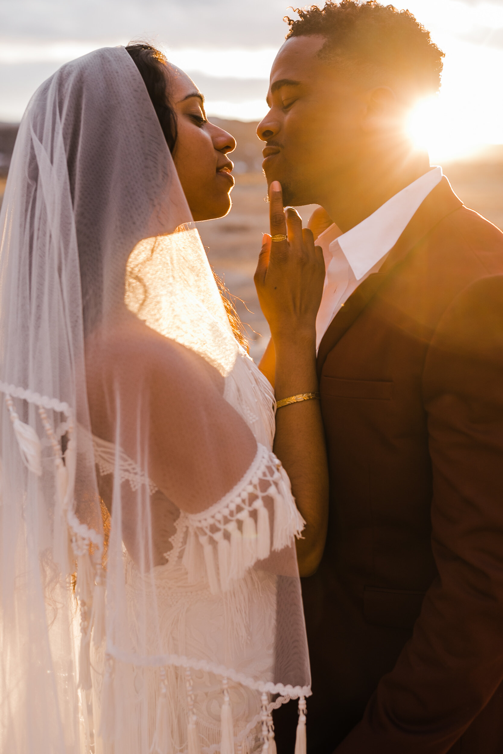 Moab Elopement Photographer | The Hearnes | Rue de Seine Dallas Gown | Bohemian Bride Fringe Wedding Dress &amp; Groom’s Burgundy Suit