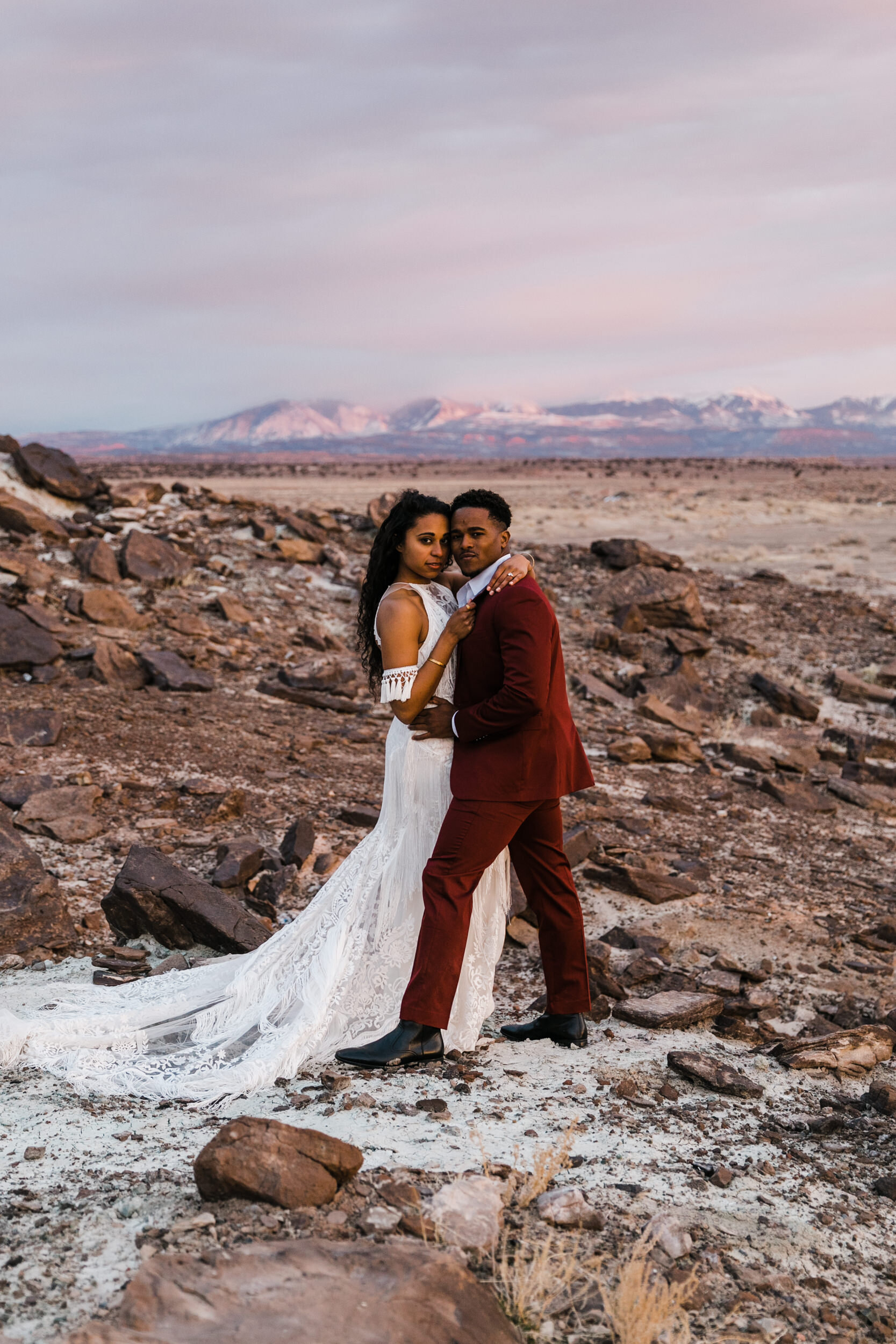 Moab Elopement Photographer | The Hearnes | Rue de Seine Dallas Gown | Bohemian Bride Fringe Wedding Dress &amp; Groom’s Burgundy Suit