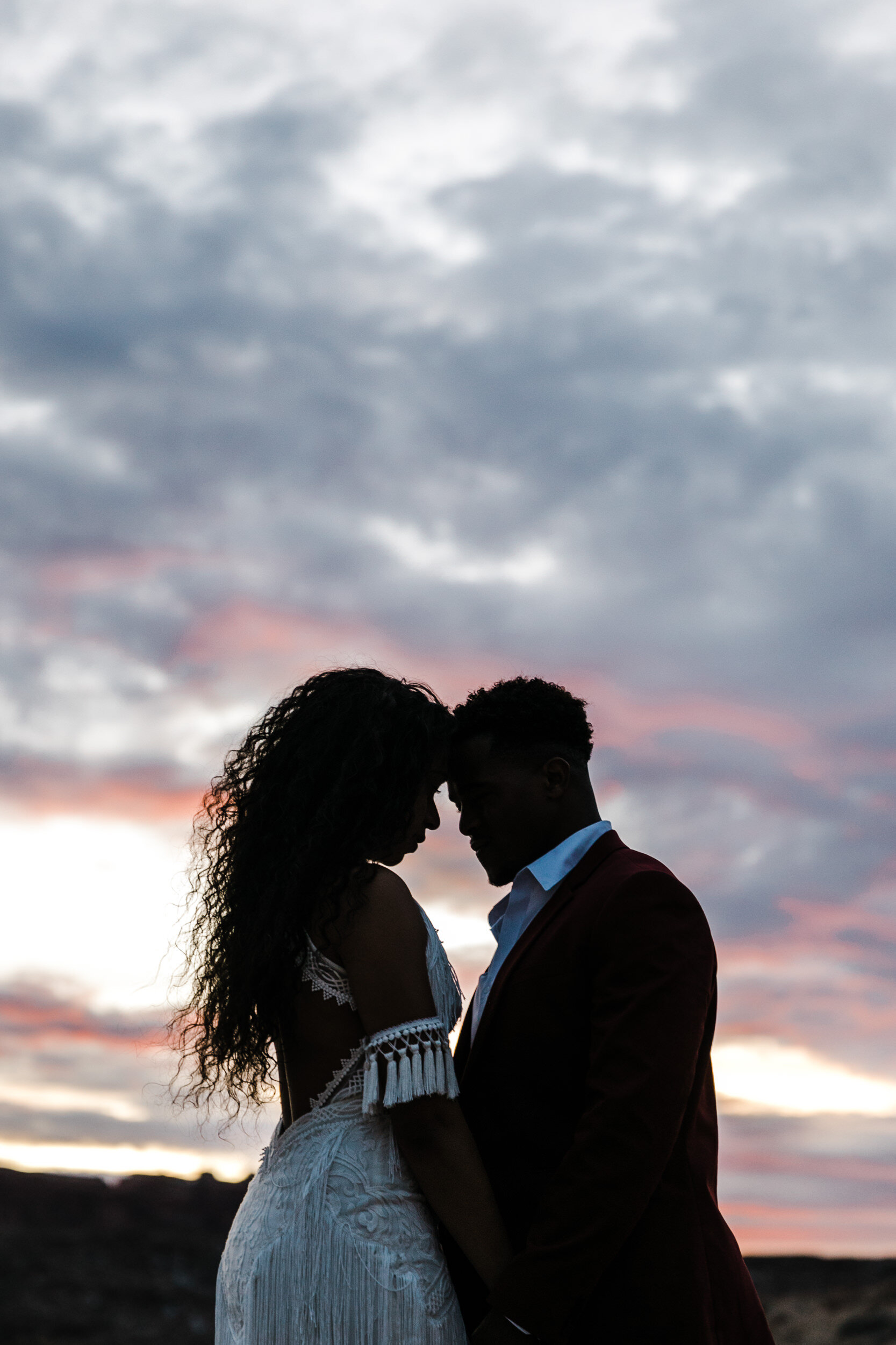 Moab Elopement Photographer | The Hearnes | Rue de Seine Dallas Gown | Bohemian Bride Fringe Wedding Dress &amp; Groom’s Burgundy Suit