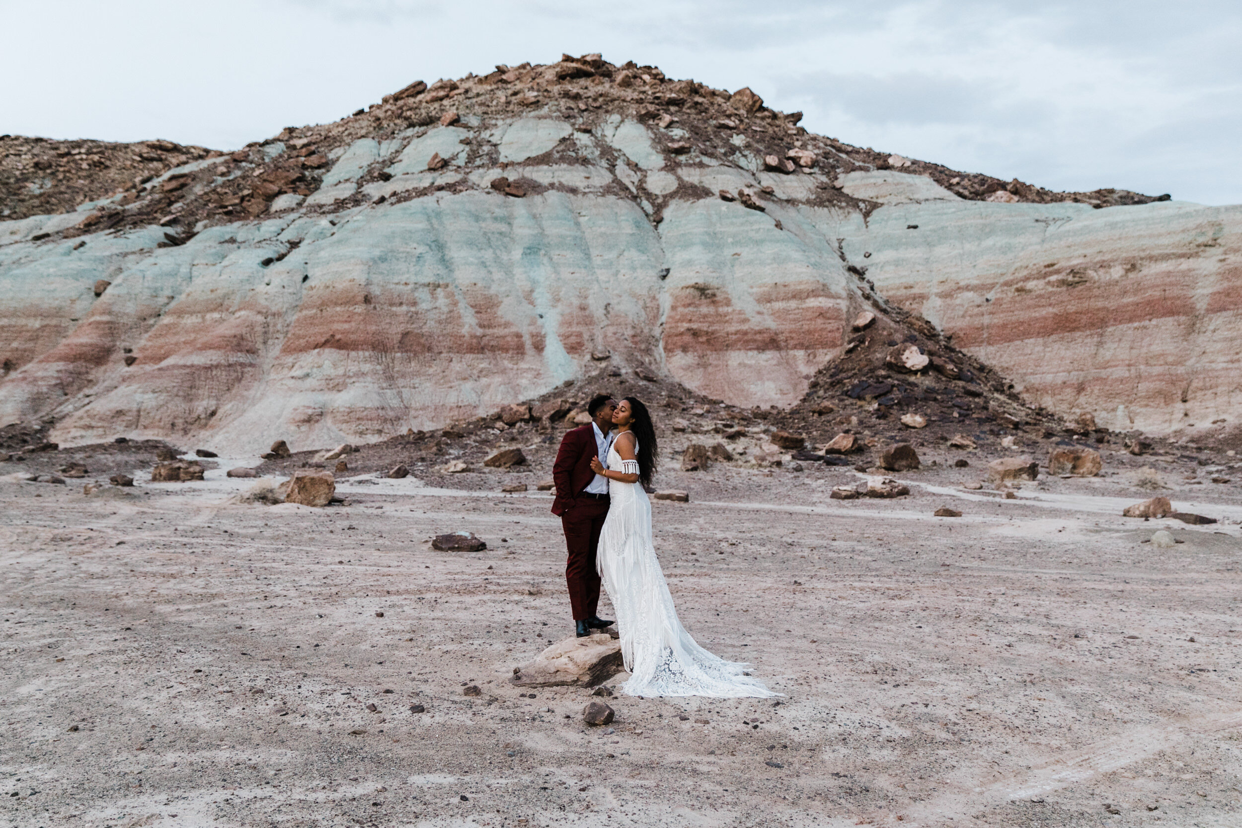 Moab Elopement Photographer | The Hearnes | Rue de Seine Dallas Gown | Bohemian Bride Fringe Wedding Dress &amp; Groom’s Burgundy Suit