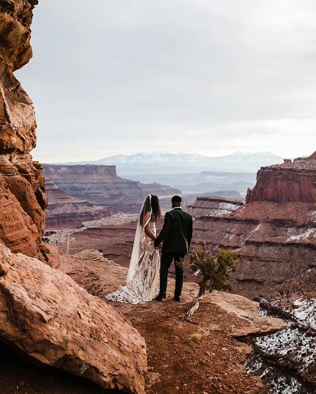 Schadell + Jamaal standing on the edge of the world soaking in the endless desert 🏜
-
Something a lot of photographers ask me about is posing our couples, specifically how we get them to look so comfortable in our photos. We have some go-to cues to direct people, but I really think the biggest thing is the whole vibe of the session. We&rsquo;re always trying to photograph how a couple truly acts together, how they&rsquo;d explore a space and soak in those moments with each other if we remove all distractions and they just focus on connection. Usually one of my favorite &ldquo;poses&rdquo; is having them turn toward the landscape and just soak it in. I love giving them a few minutes to do this usually at the beginning and near the end of the session, I like to think it&rsquo;s the moment they&rsquo;ll remember when thinking through our time together. We never want their memories to be rushing from one spot to the next, or being overly-directed for &ldquo;the shot.&rdquo; We know we&rsq