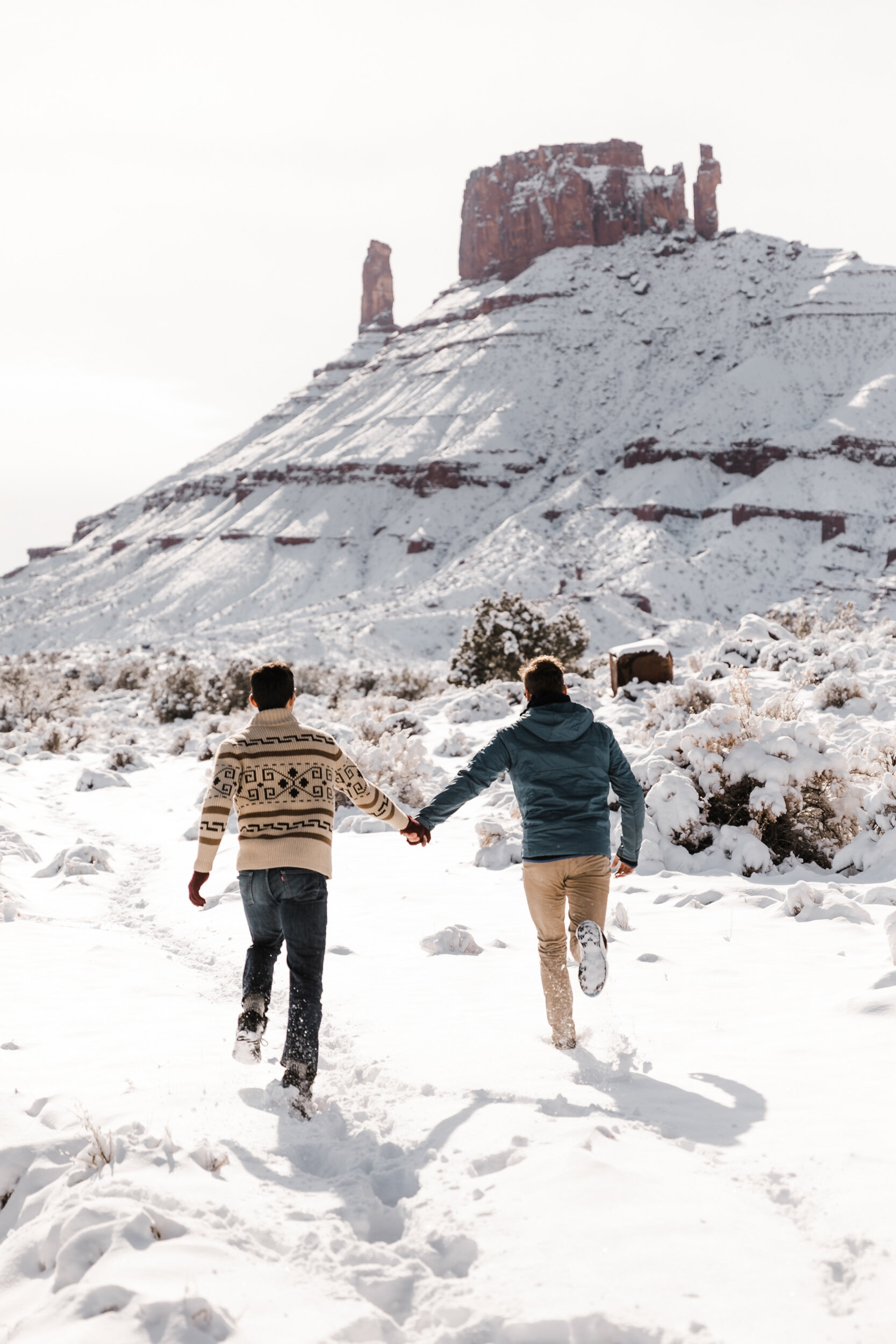 LGBTQ+ Elopement Photographer | Casual Adventure Session in Moab, Utah | Snowy Desert Towers + Two Gay Climbers in Love