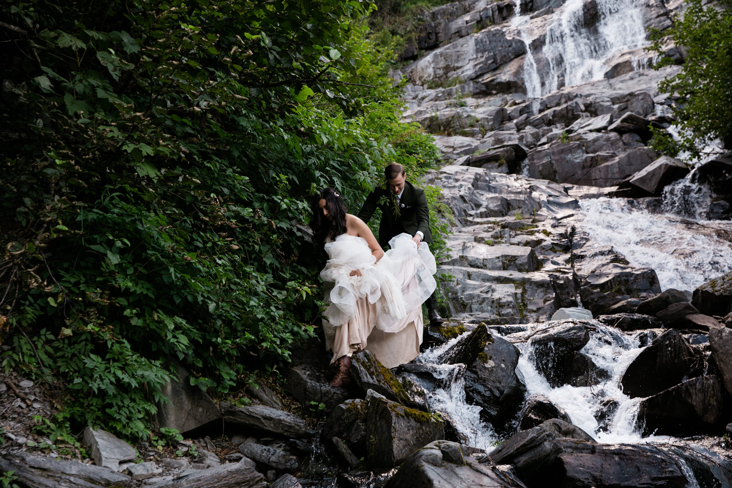 waterfall elopement in alaska | blush colored wedding dress | dark green groom suit | the hearnes adventure photography