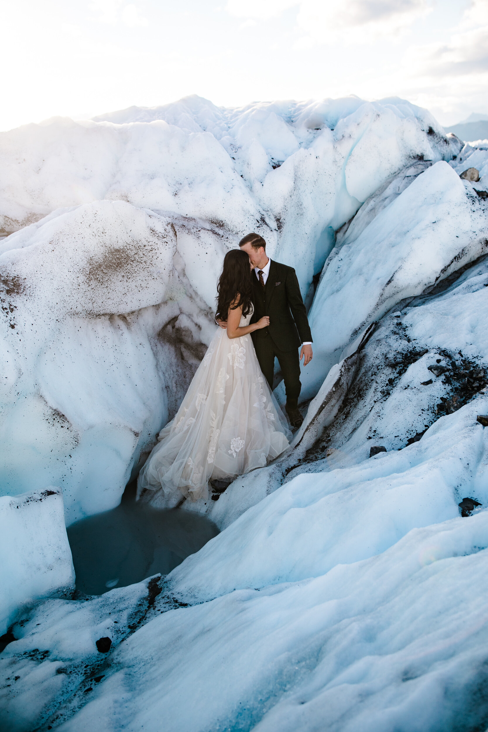 Glacier Hiking Elopement in Alaska | Day-After Wedding Session | Blush Wedding Dress | Dark Green Groom Suit | The Hearnes Adventure Photography