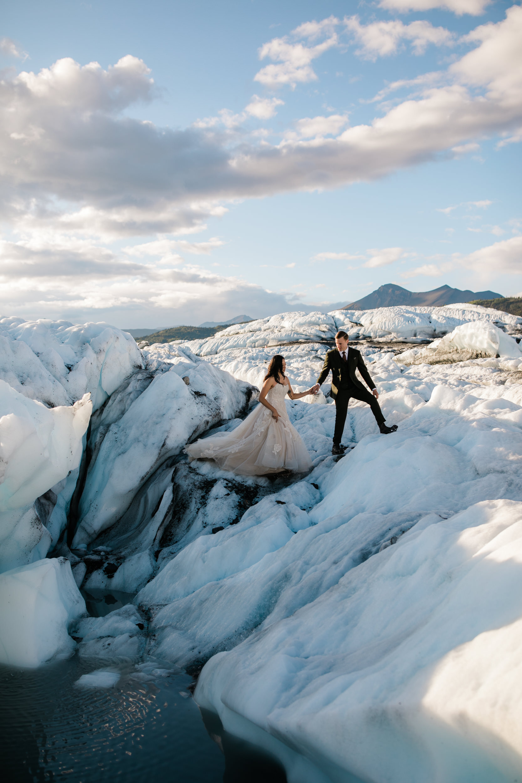 Glacier Hiking Elopement in Alaska | Day-After Wedding Session | Blush Wedding Dress | Dark Green Groom Suit | The Hearnes Adventure Photography
