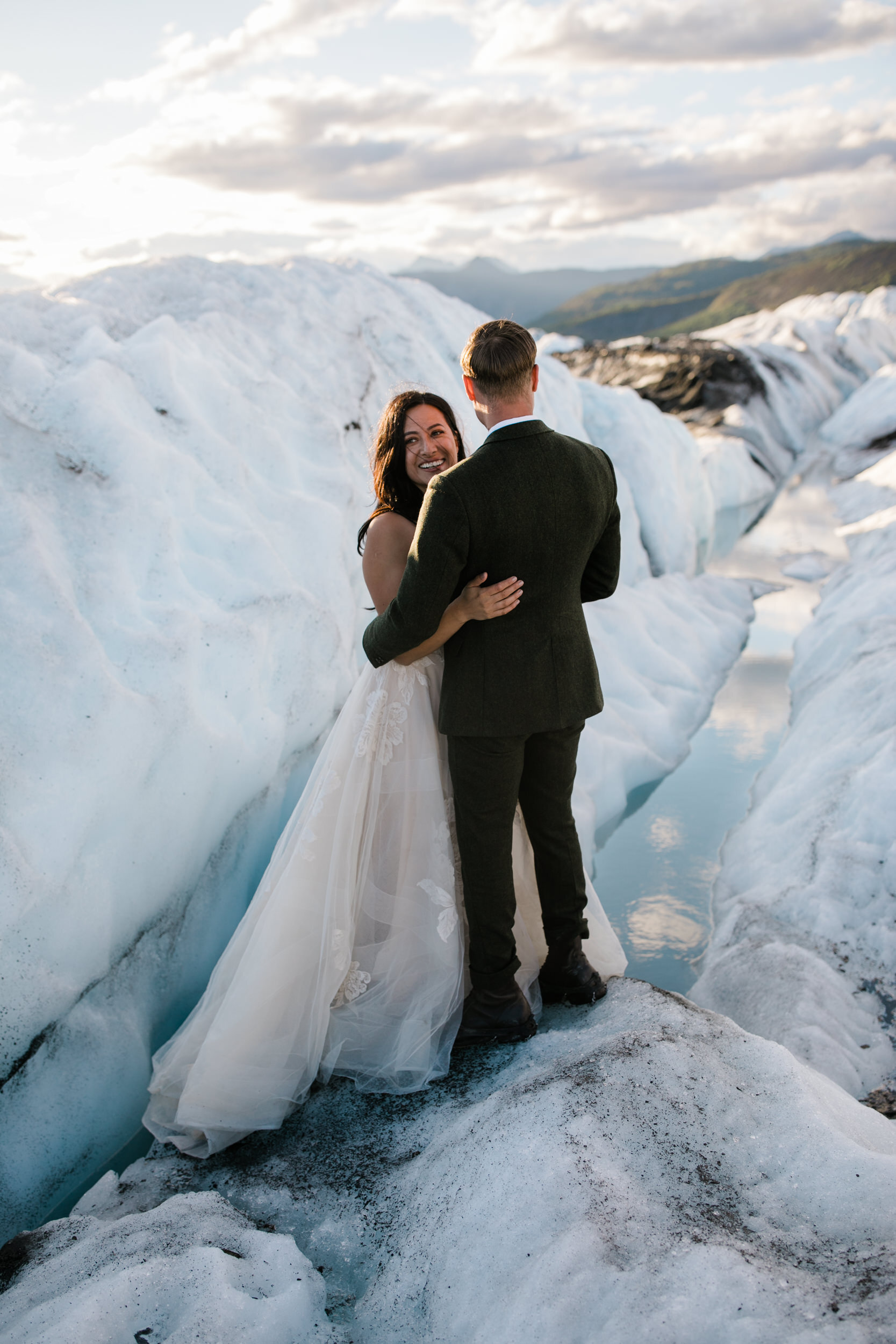 Glacier Hiking Elopement in Alaska | Day-After Wedding Session | Blush Wedding Dress | Dark Green Groom Suit | The Hearnes Adventure Photography