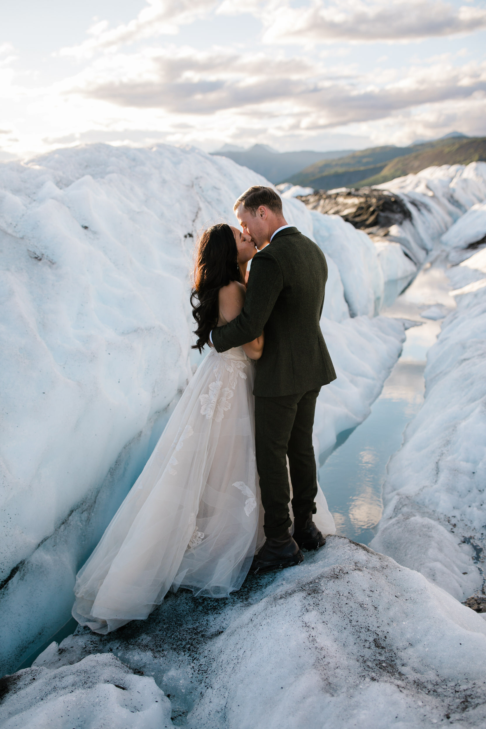 Glacier Hiking Elopement in Alaska | Day-After Wedding Session | Blush Wedding Dress | Dark Green Groom Suit | The Hearnes Adventure Photography