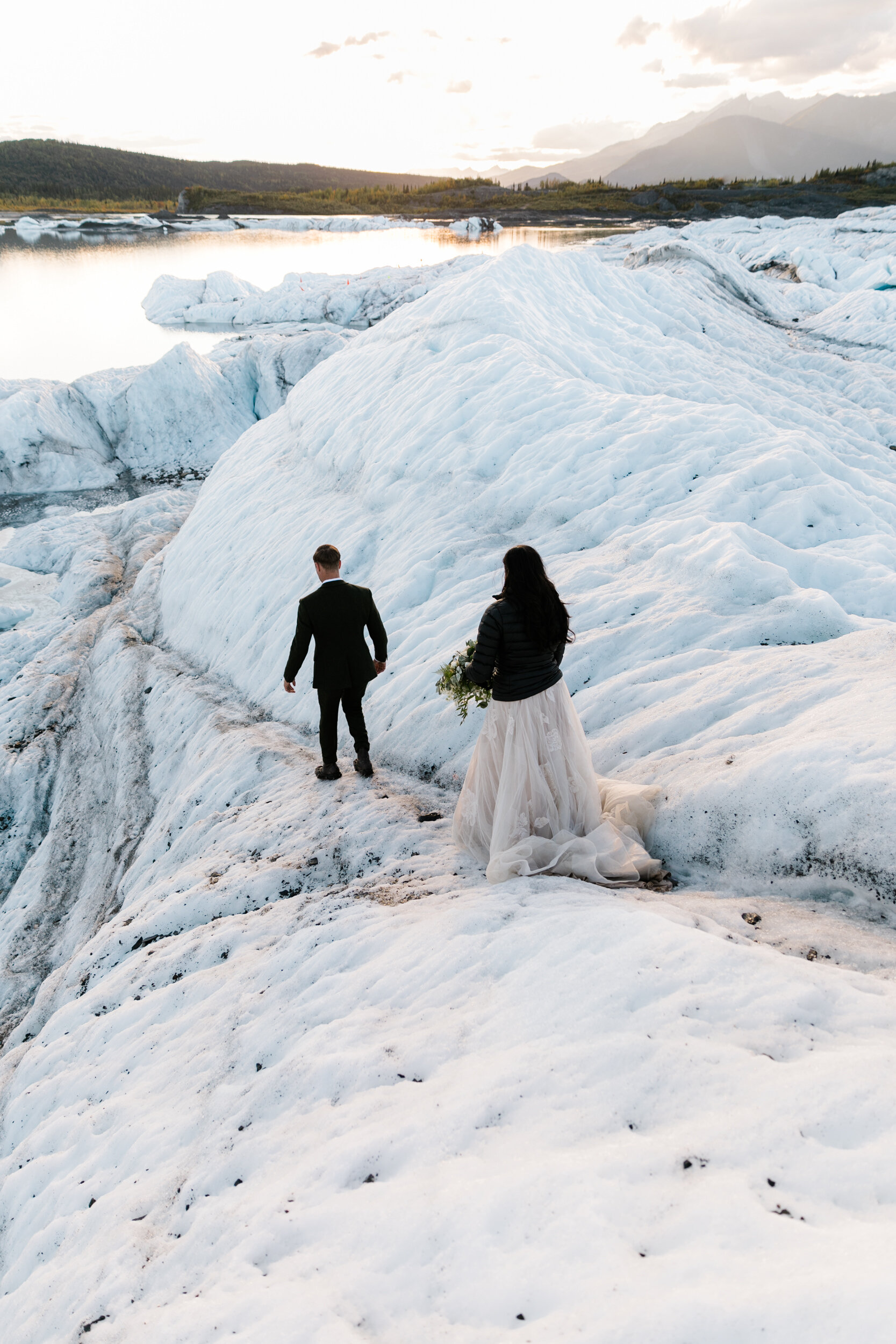 Glacier Hiking Elopement in Alaska | Day-After Wedding Session | Blush Wedding Dress | Dark Green Groom Suit | The Hearnes Adventure Photography