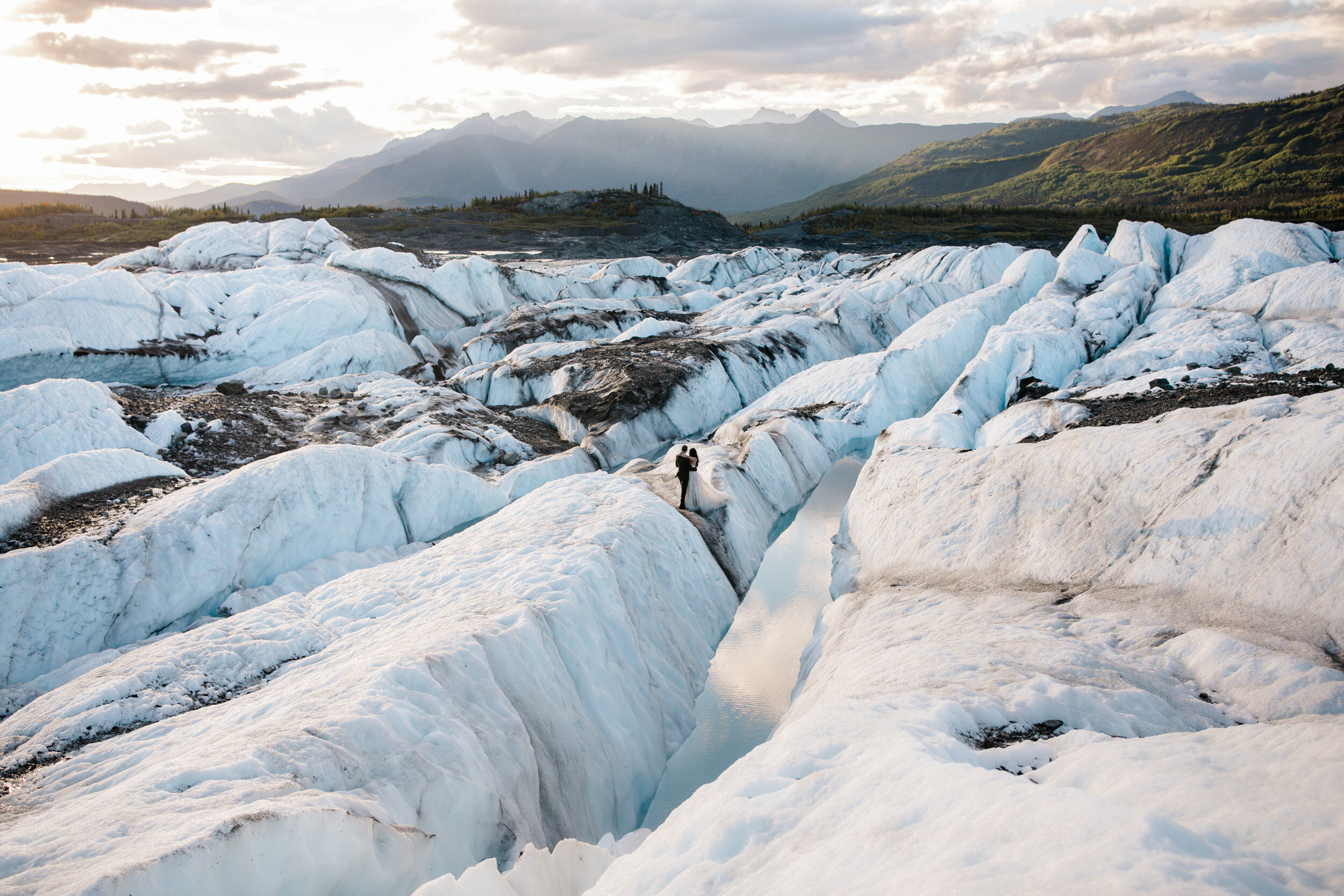 Glacier Hiking Elopement in Alaska | Day-After Wedding Session | Blush Wedding Dress | Dark Green Groom Suit | The Hearnes Adventure Photography