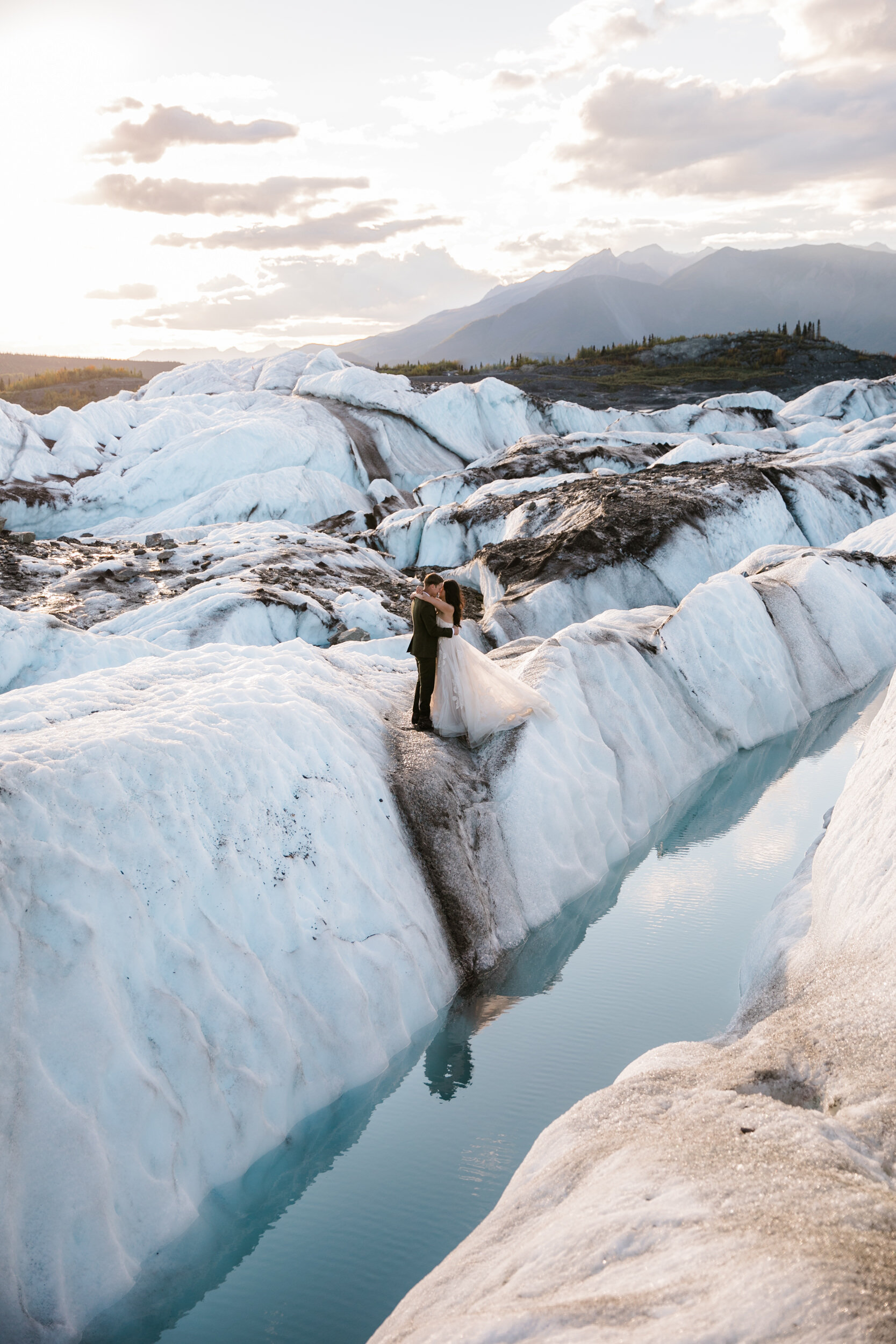 Glacier Hiking Elopement in Alaska | Day-After Wedding Session | Blush Wedding Dress | Dark Green Groom Suit | The Hearnes Adventure Photography