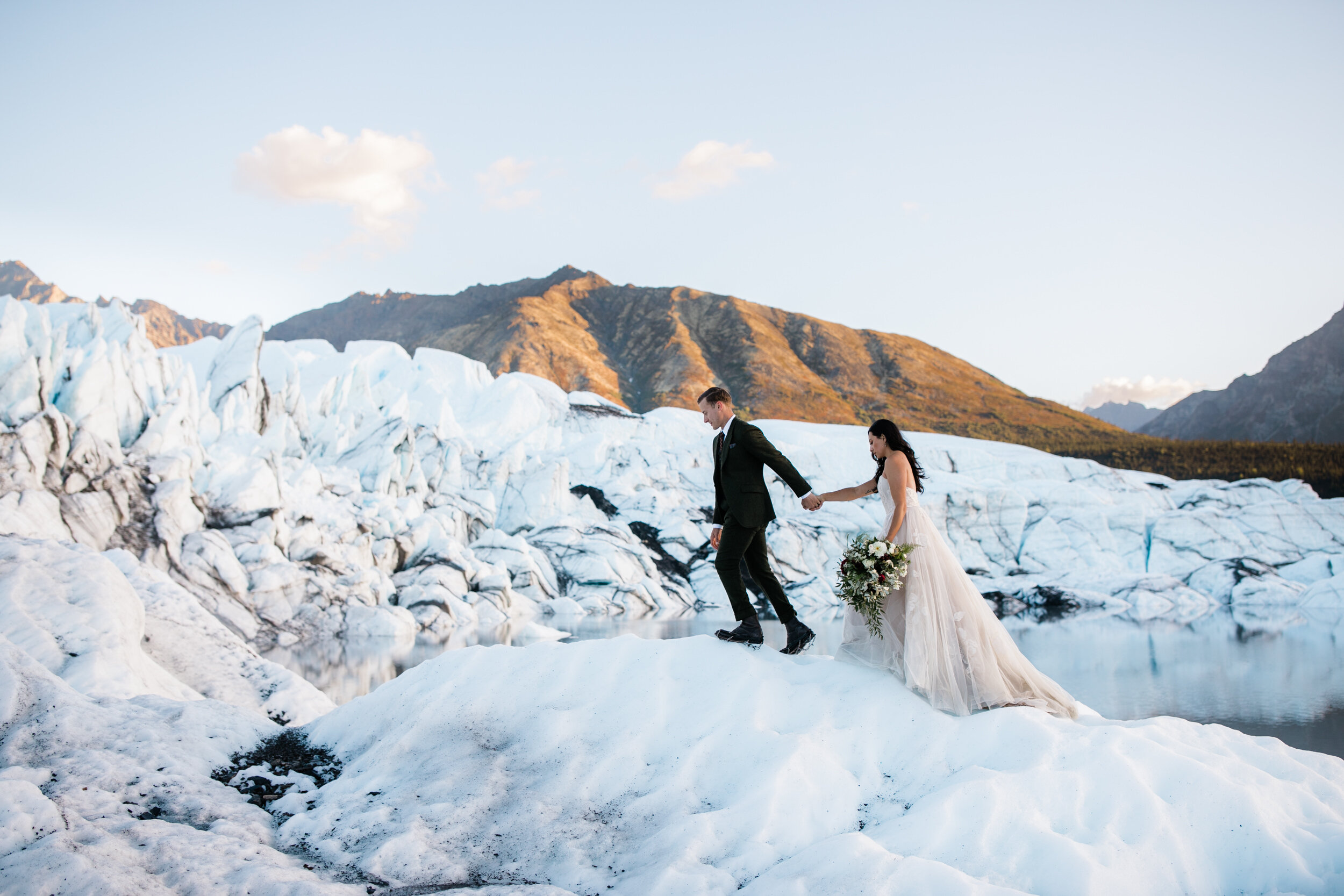 Glacier Hiking Elopement in Alaska | Day-After Wedding Session | Blush Wedding Dress | Dark Green Groom Suit | The Hearnes Adventure Photography