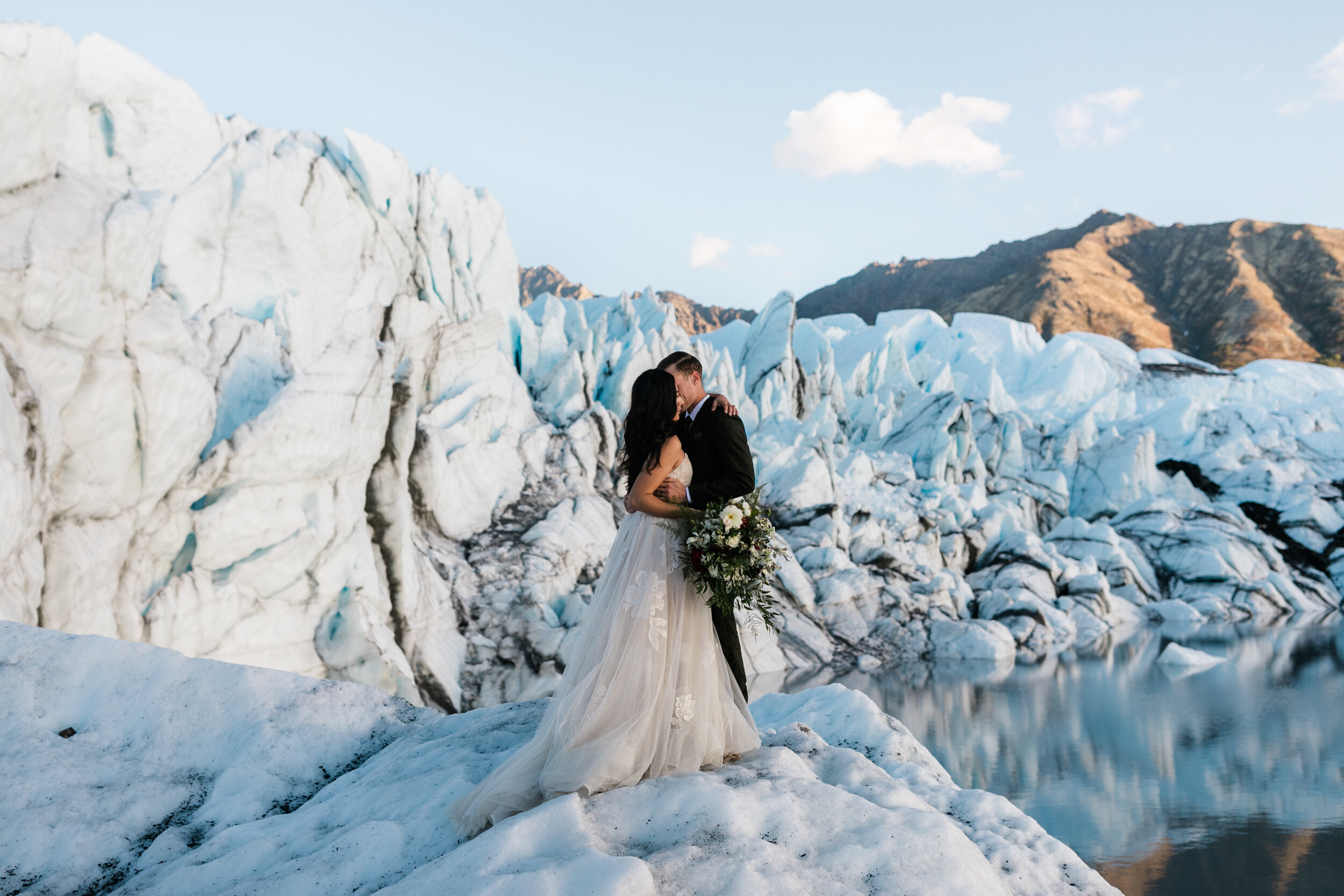 Glacier Hiking Elopement in Alaska | Day-After Wedding Session | Blush Wedding Dress | Dark Green Groom Suit | The Hearnes Adventure Photography