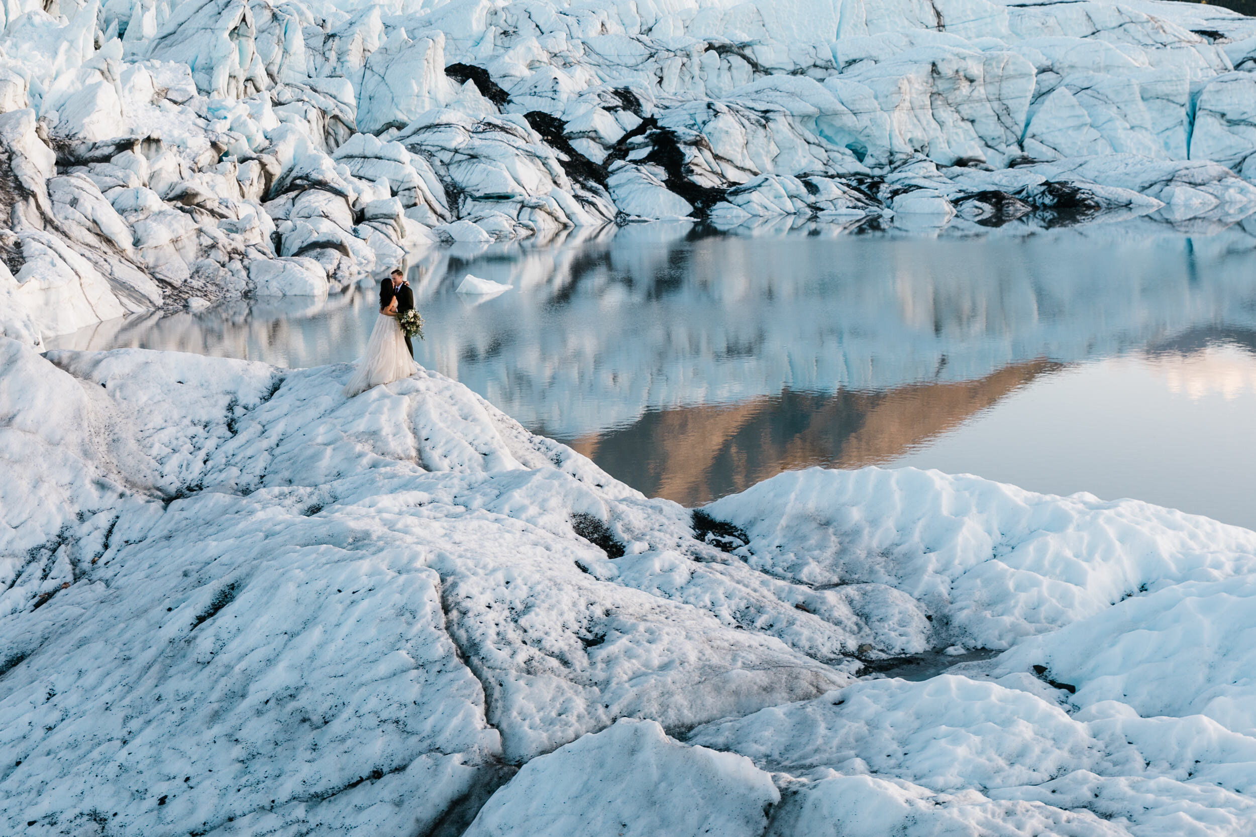 Glacier Hiking Elopement in Alaska | Day-After Wedding Session | Blush Wedding Dress | Dark Green Groom Suit | The Hearnes Adventure Photography