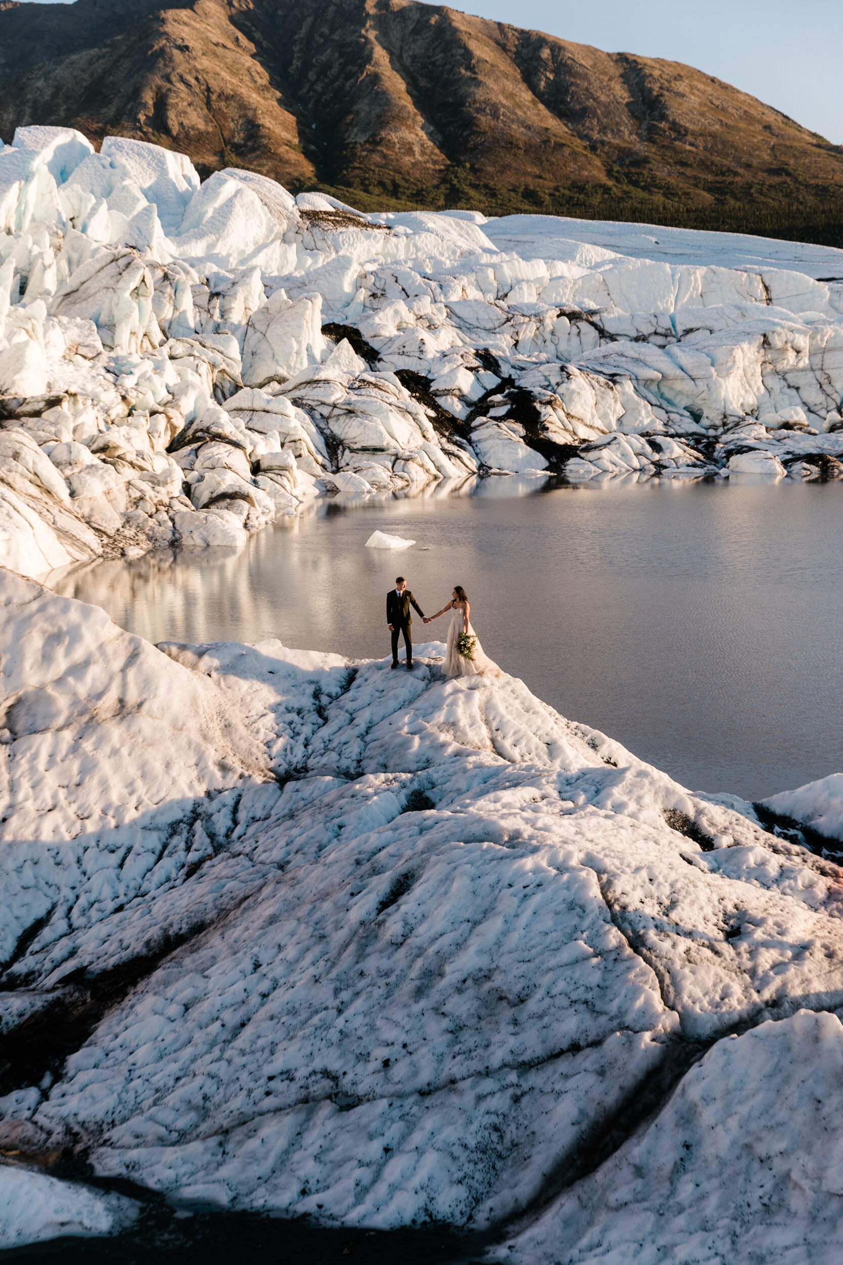 Glacier Hiking Elopement in Alaska | Day-After Wedding Session | Blush Wedding Dress | Dark Green Groom Suit | The Hearnes Adventure Photography